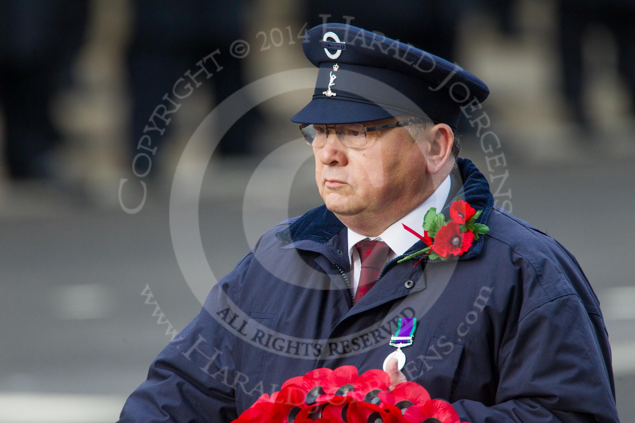 Remembrance Sunday at the Cenotaph in London 2014: The representative of Transport for London walking towards the Cenotaph with his wreath.
Press stand opposite the Foreign Office building, Whitehall, London SW1,
London,
Greater London,
United Kingdom,
on 09 November 2014 at 11:27, image #313