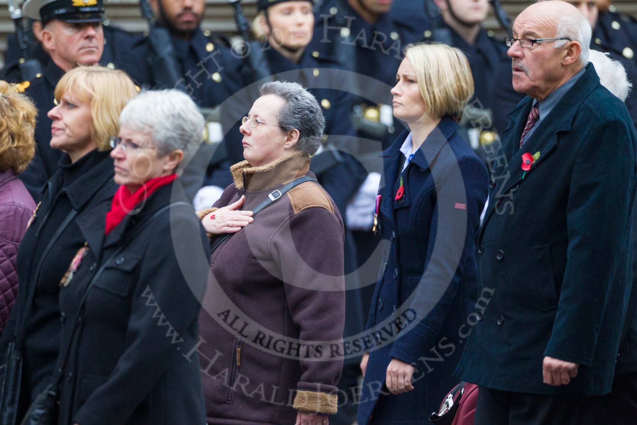 Remembrance Sunday at the Cenotaph 2015: Group M23, Civilians Representing Families.
Cenotaph, Whitehall, London SW1,
London,
Greater London,
United Kingdom,
on 08 November 2015 at 12:17, image #1567