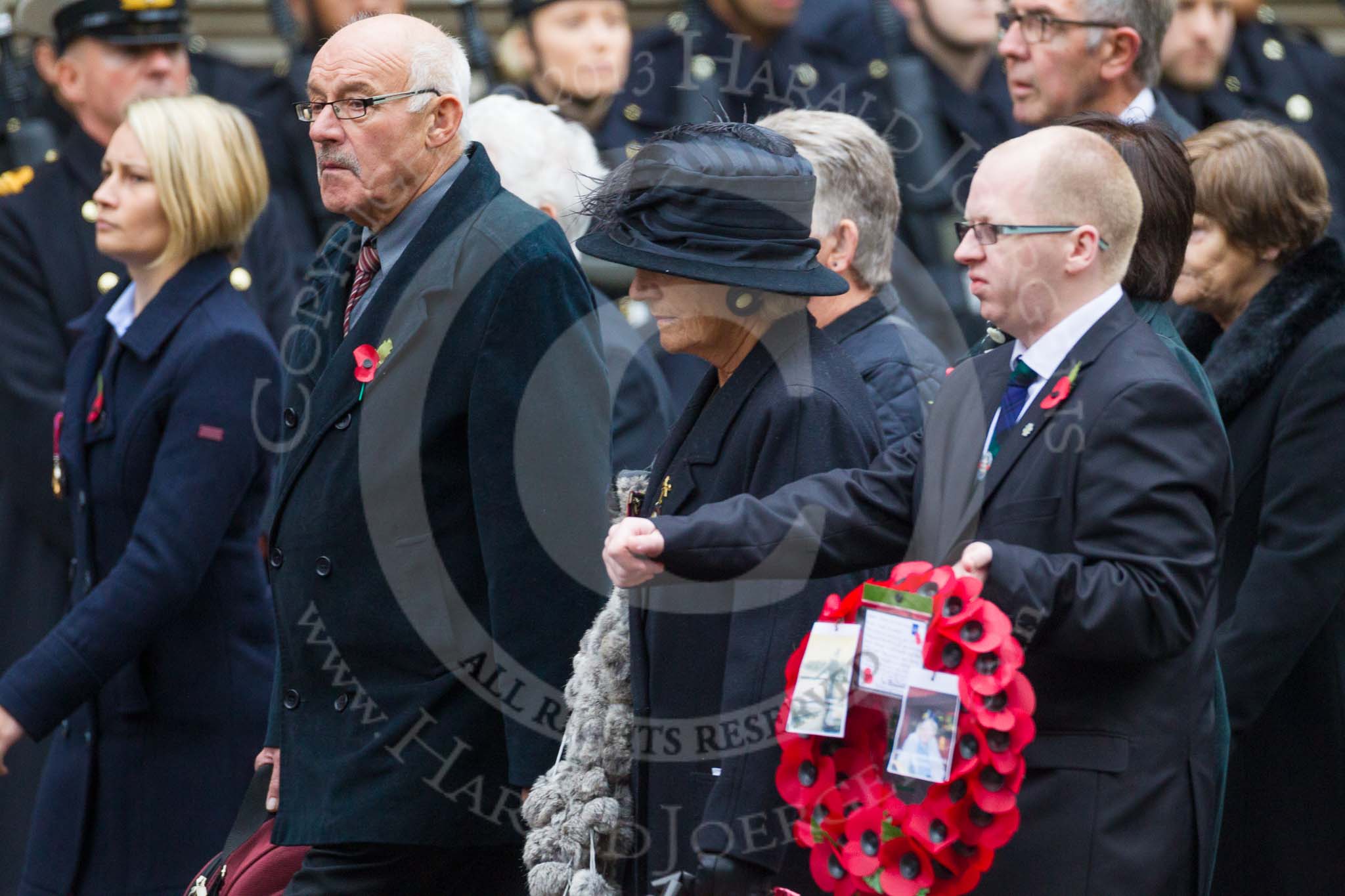 Remembrance Sunday at the Cenotaph 2015: Group M23, Civilians Representing Families.
Cenotaph, Whitehall, London SW1,
London,
Greater London,
United Kingdom,
on 08 November 2015 at 12:17, image #1568