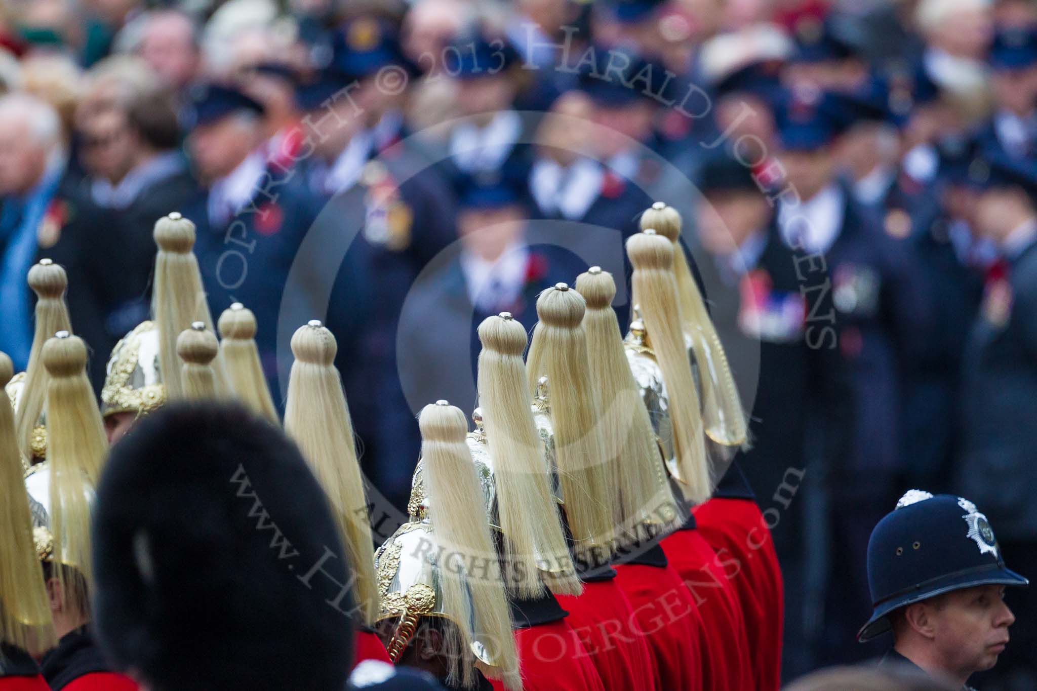 Remembrance Sunday at the Cenotaph 2015: The helmets of the Household Cavalry detachment, in the background, and out of focus, the Transport for London group waiting for the March Past. Image #356, 08 November 2015 11:35 Whitehall, London, UK