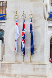Remembrance Sunday at the Cenotaph 2015: The Cenotaph in the morning of Remembrance Sunday 2015. The tree flags represent the Royal Navy, the British Army, the Royal Air Force, and the Merchant Navy. Image #2, 08 November 2015 08:20 Whitehall, London, UK