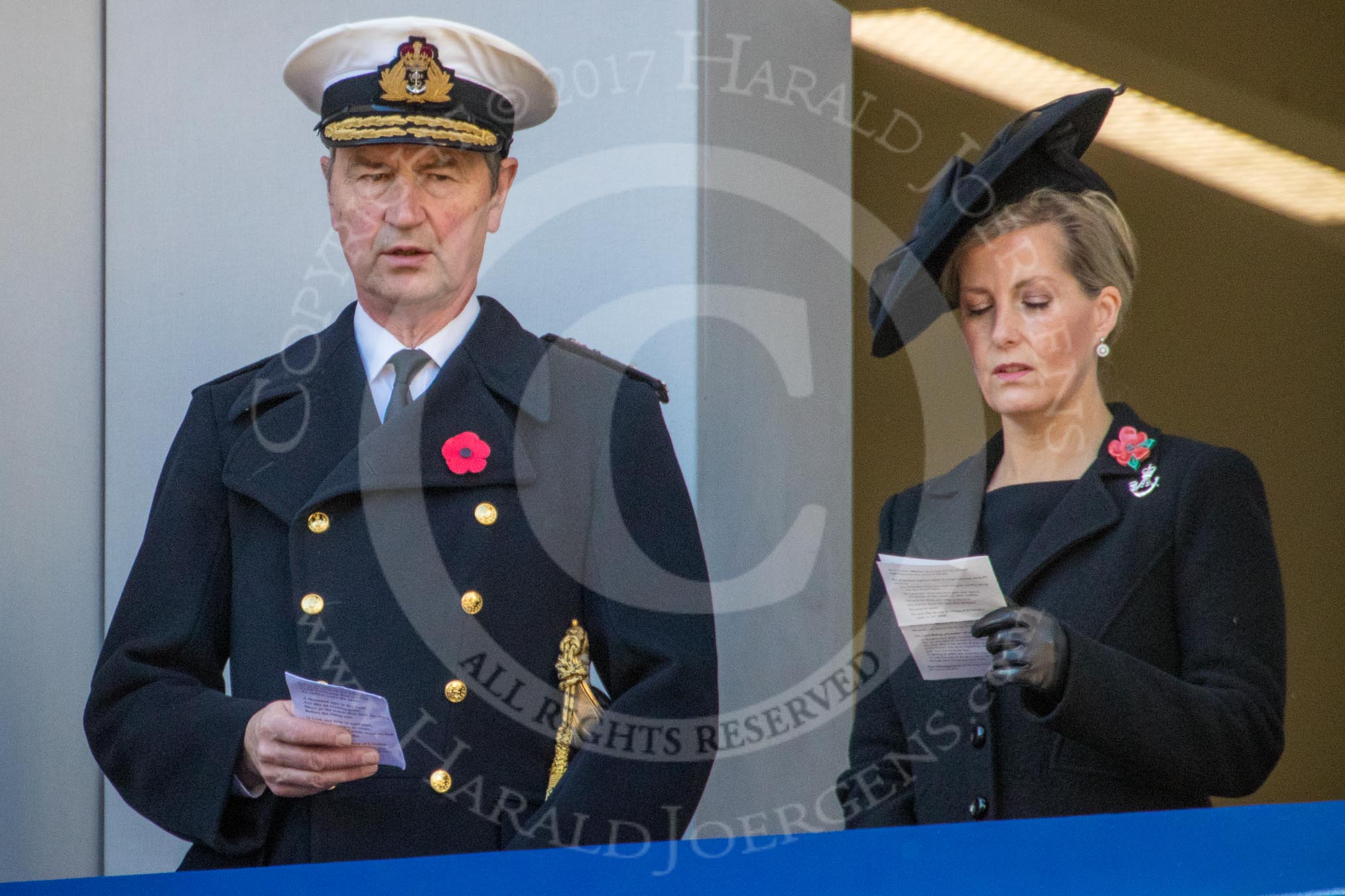 Vice Admiral Sir Tim Laurence, husband of HRH The Princess Royal and HRH The Countess of Wessex (Sophie) , singing, on the balcony of the Foreign and Commonwealth Office during the Remembrance Sunday Cenotaph Ceremony 2018 at Horse Guards Parade, Westminster, London, 11 November 2018, 11:18.