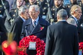 The Rt Hon The Lord Fowler, Lord Speaker, (on behalf of Parliament representing members of the House of Lords)   carrying his wreath during the Remembrance Sunday Cenotaph Ceremony 2018 at Horse Guards Parade, Westminster, London, 11 November 2018, 10:55. Behind him former prime ministers Gordon Brown and Tony Blair.