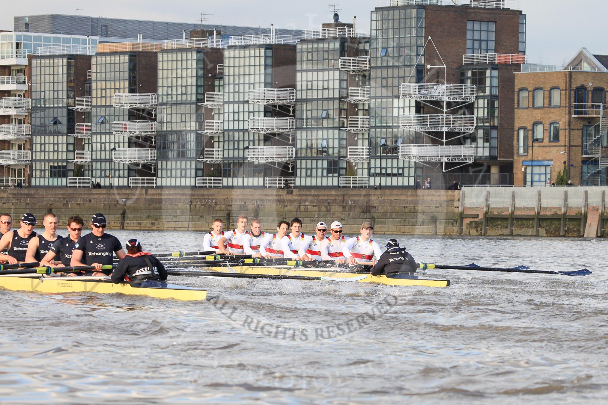 The Boat Race season 2012 - fixture OUBC vs German U23: In the Oxford Blue Boat - Dr. Hanno Wienhausen, Karl Hudspith, Alex Davidson, Dan Harvey, stern Roel Haen, cox Zoe de Toledo, in the German U23 boat - bow Maximilian Johanning, Rene Stüven, Robin Ponte, Alexander Thierfelder, Malte Jakschik, Maximilian Planer, Felix Wimberger, stern Lukas-Frederik Müller, cox Oskar Zorilla. In the background the Thames Reach housing scheme..
River Thames between Putney and Mortlake,
London,

United Kingdom,
on 26 February 2012 at 15:30, image #67