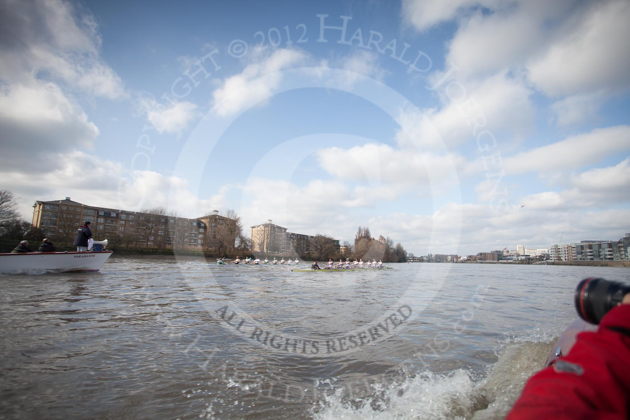 The Boat Race season 2012 - fixture CUBC vs Leander: CUBC (left) and Leander Club Eight reaching the Mile Post on the way to the Surrey Bend, with Hammersmith Bridge in the background. On the left Handel Mansions and Holst Mansions, followed by the Harrods Depository..
River Thames between Putney and Molesey,
London,
Greater London,
United Kingdom,
on 10 March 2012 at 14:17, image #128