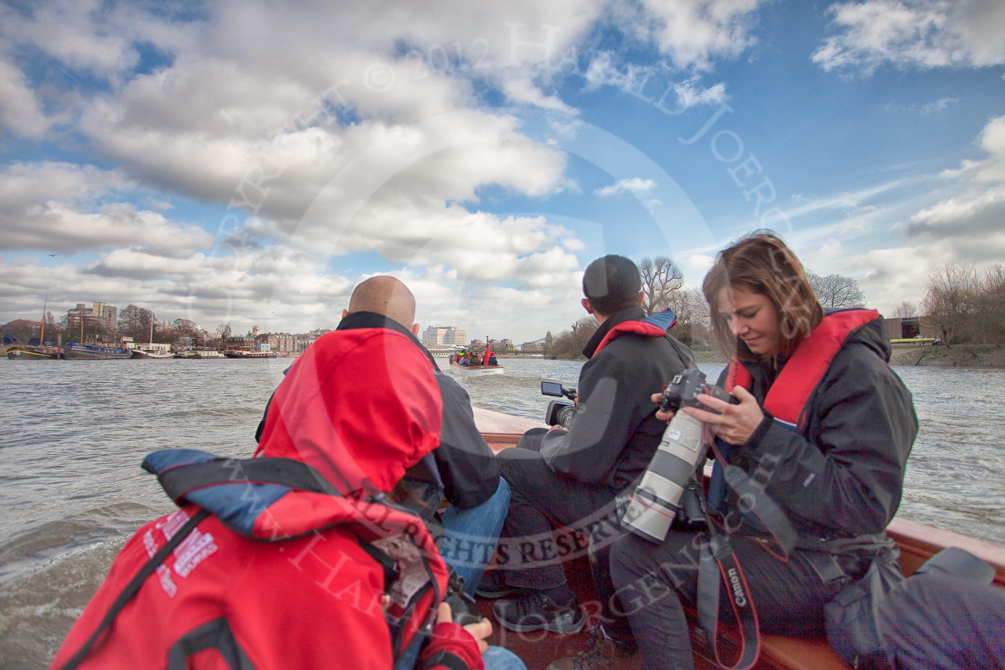 The Boat Race season 2012 - fixture CUBC vs Leander: The press launch, carrying photographers and television crews, returning to base after the CUBC vs Leander fixture, on the way to Putney Bridge..
River Thames between Putney and Molesey,
London,
Greater London,
United Kingdom,
on 10 March 2012 at 14:24, image #152