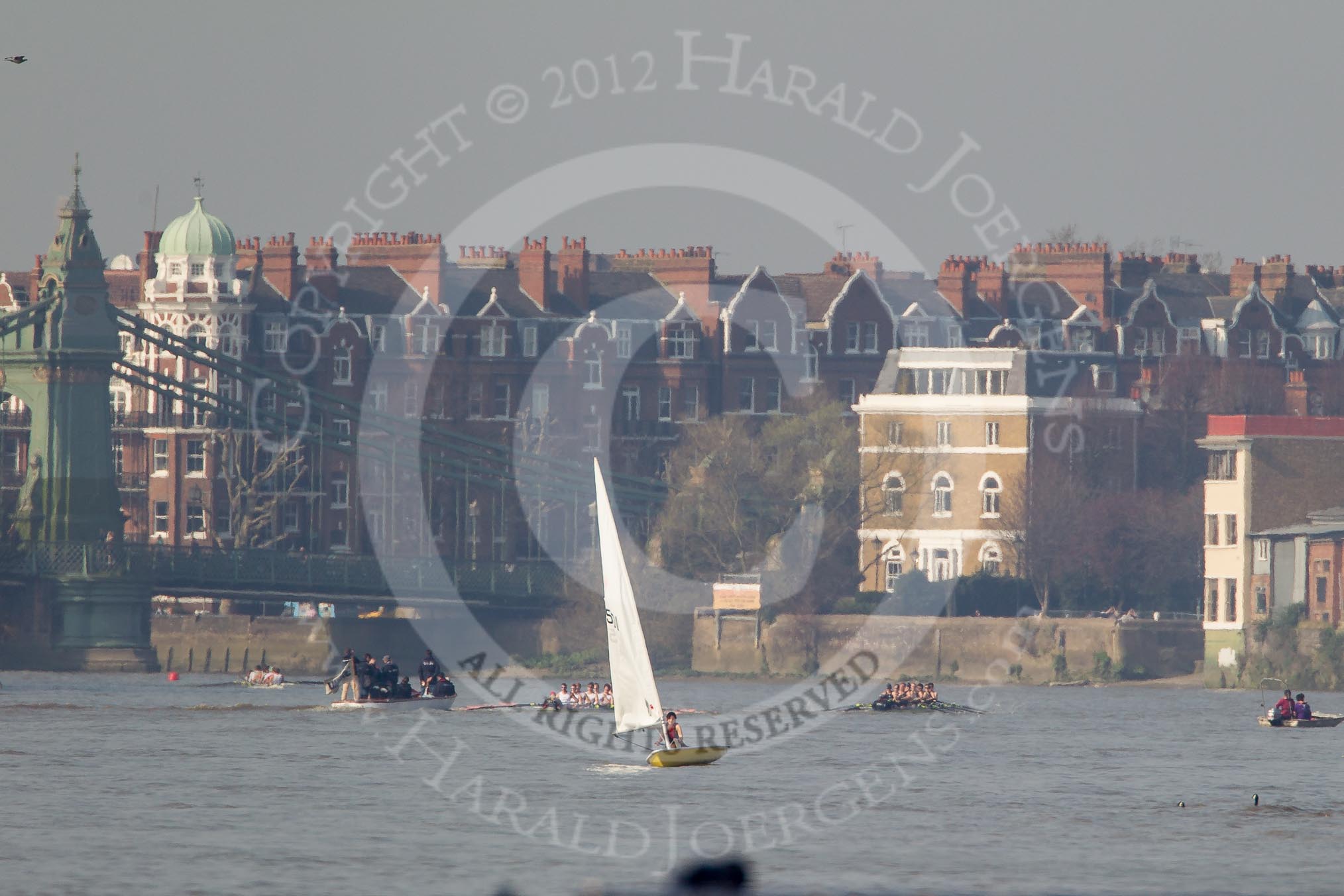 The Boat Race season 2012 - fixture OUBC vs Leander: Approaching Hammersmith Bridge, the OUBC Blue Boat in the lead, Leander, followed by umpire Richard Phelps, behind. Just visible under Hammersmith Bridge the CUBC Blue Boat..




on 24 March 2012 at 14:33, image #142