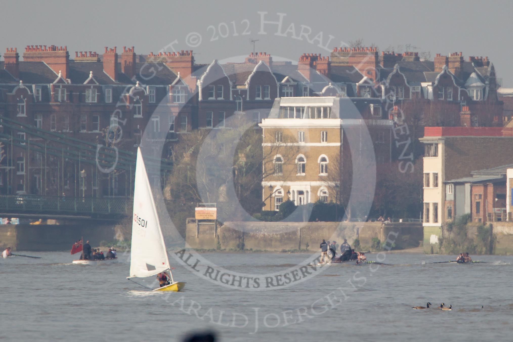 The Boat Race season 2012 - fixture OUBC vs Leander: Approaching Hammersmith Bridge, the OUBC Blue Boat in the lead, Leander, followed by umpire Richard Phelps, behind. Just visible under Hammersmith Bridge the CUBC Blue Boat..




on 24 March 2012 at 14:33, image #144