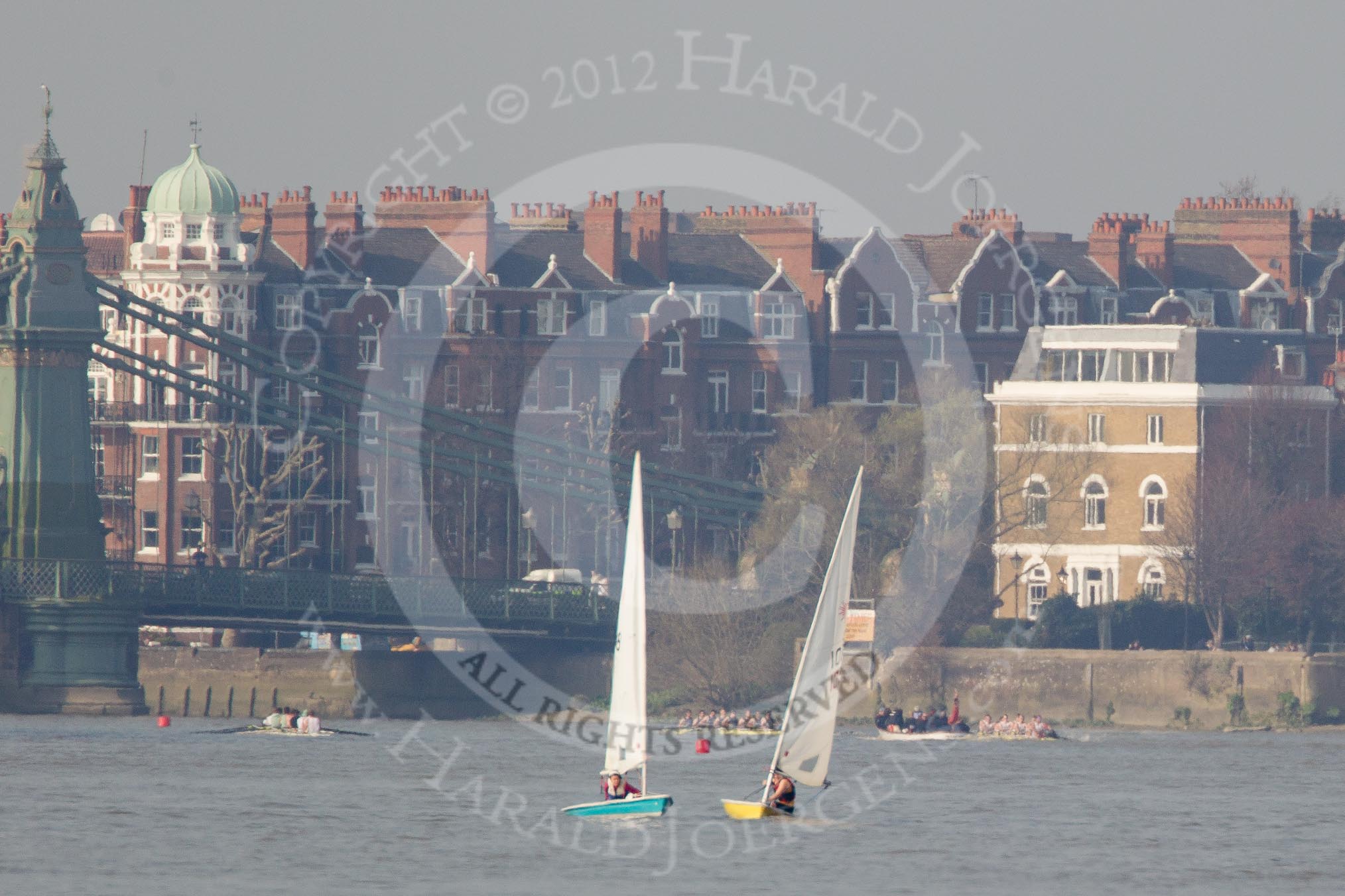 Photo 1203241434241D43144HaraldJoergens The Boat Race season 2012 - fixture OUBC vs Leander: Approaching Hammersmith Bridge, the OUBC Blue Boat on the right, Leander on the left, both followed by umpire Richard Phelps. Coming the other way, on the left of the image, the Cambridge Blue Boat..
on 24 March 2012 at 14:34, image #149