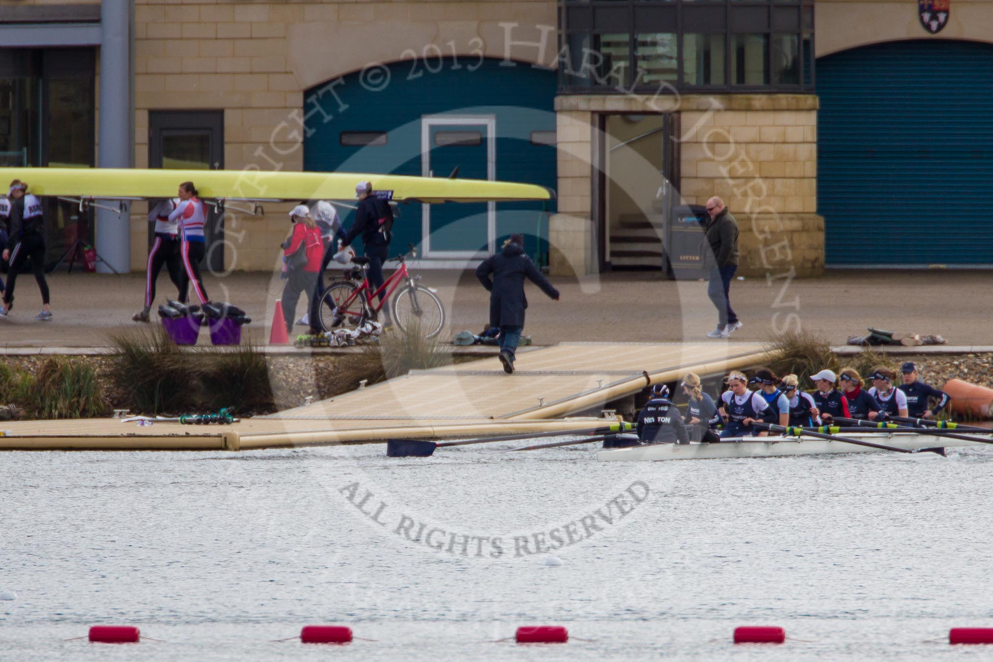 The Boat Race season 2013 - fixture OUWBC vs Olympians: The OUWBC Blue Boat alongside a pontoon an Dorney Lake after the training session whilst the Olympians are carrying their boat away..
Dorney Lake,
Dorney, Windsor,
Buckinghamshire,
United Kingdom,
on 16 March 2013 at 12:31, image #330