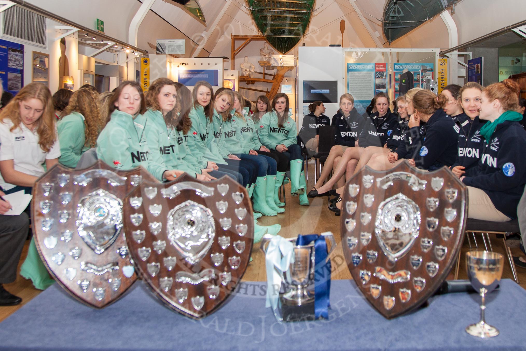 The Boat Race Season 2013 - Henley Boat Races Challenge: Sitting behind the Henley Boat Races trophies, the Cambridge University crews on the left and Oxford University on the right, at the Schwarzenbach International Gallery, Henley River and Rowing Museum..
River and Rowing Museum,
H,


on 19 March 2013 at 10:43, image #4