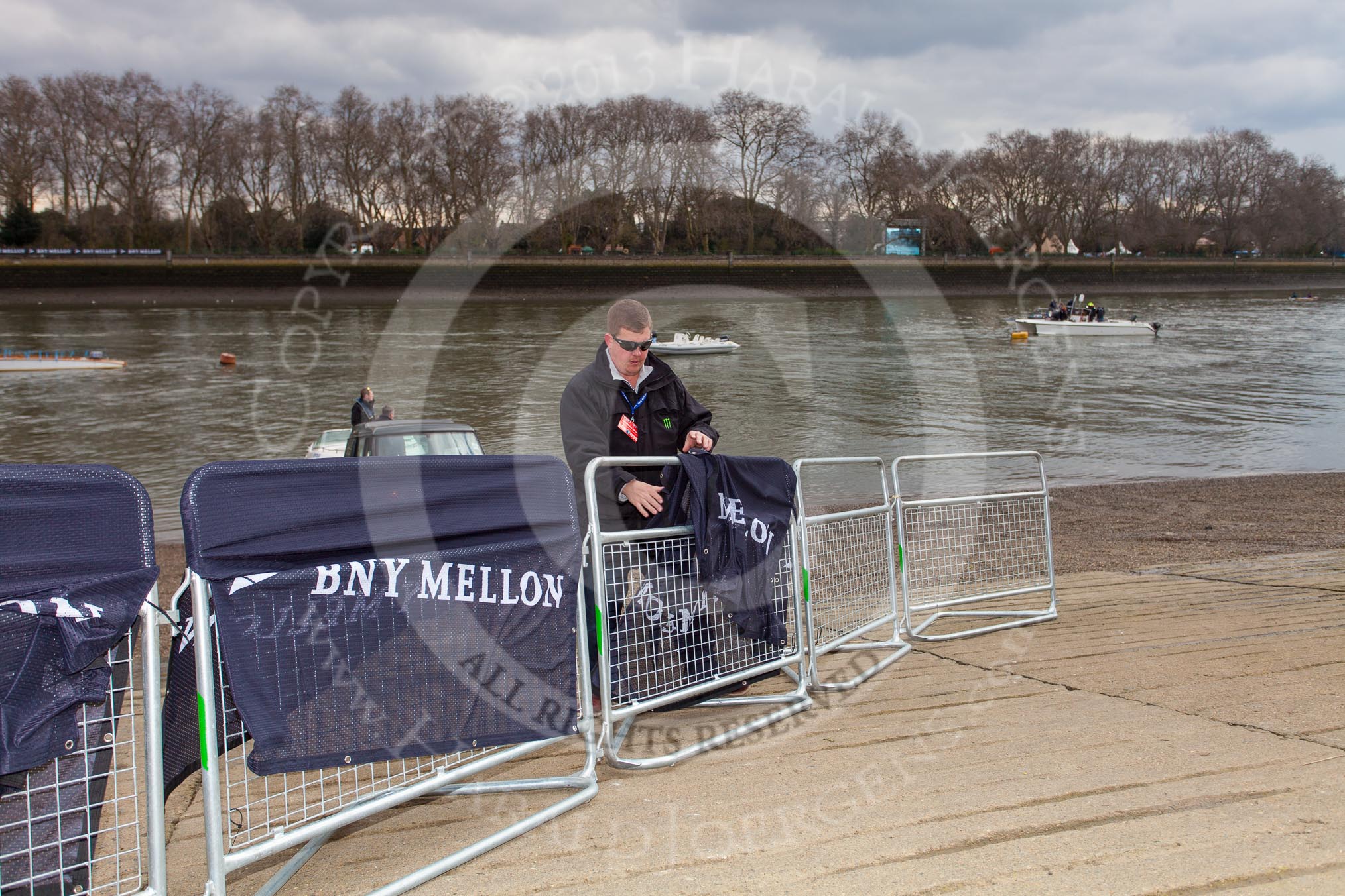 The Boat Race 2013: Getting ready for the 2013 Boat Race - covering barriers with logos of the sponsor of the event, BNY Mellon..
Putney,
London SW15,

United Kingdom,
on 31 March 2013 at 11:10, image #8