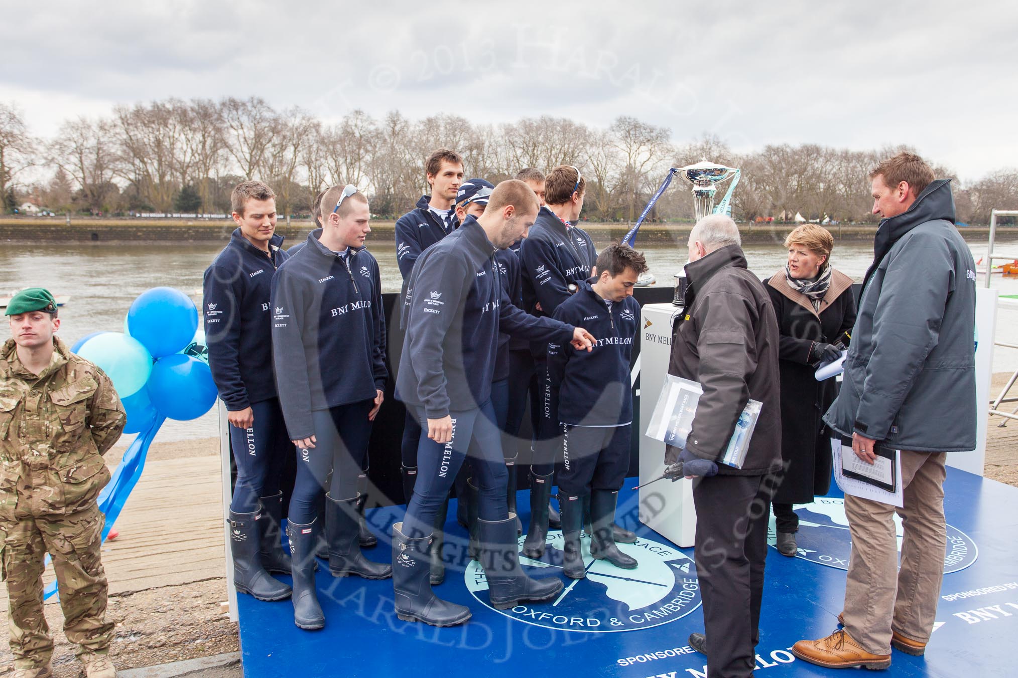 The Boat Race 2013: The Oxford Blue Boat crew with BBC Sport commentator and Boat Race umpire Sir Matthew Pinsent and the Boat Race Trophy at the "toss for stations"..
Putney,
London SW15,

United Kingdom,
on 31 March 2013 at 14:44, image #91