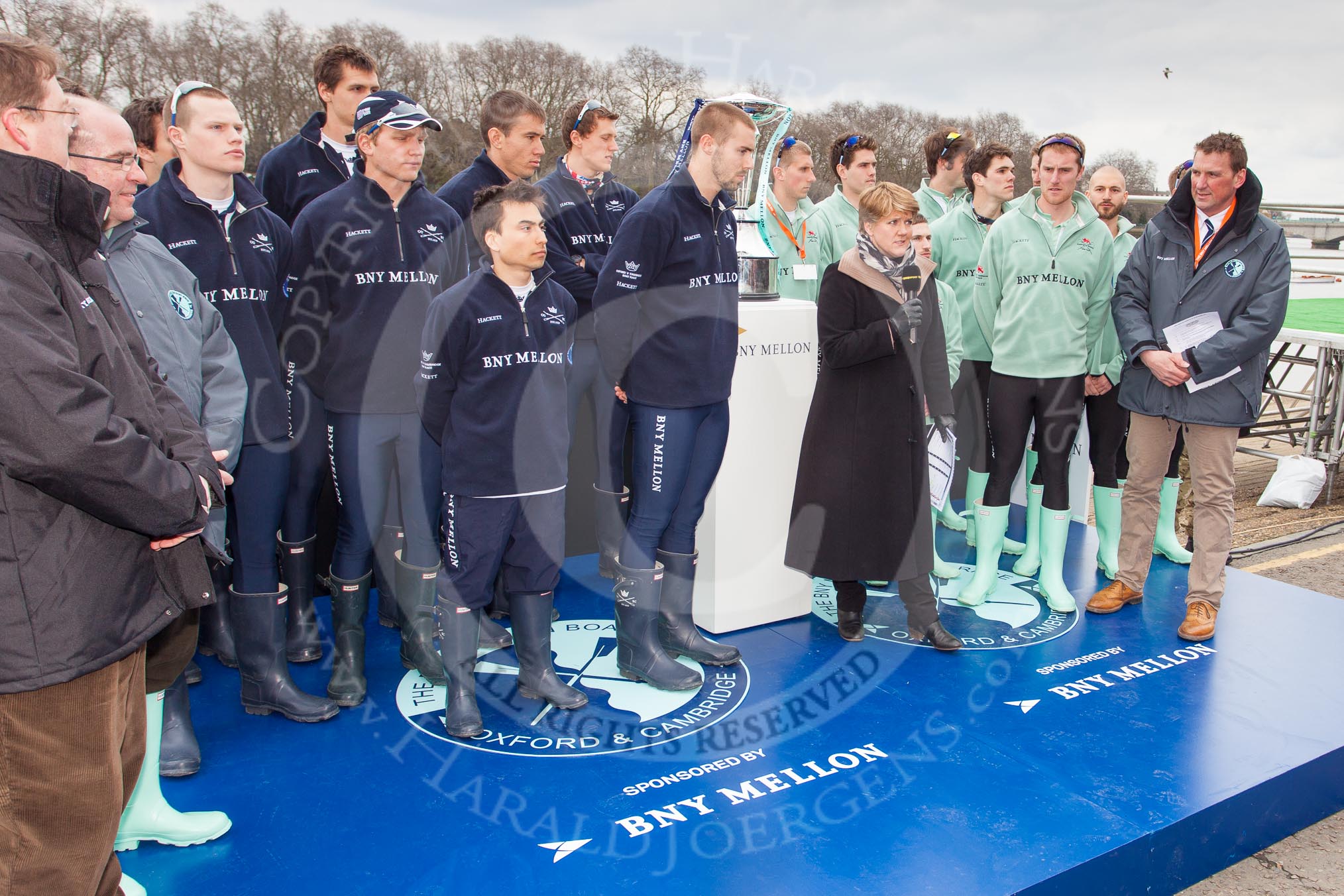 The Boat Race 2013: The "toss for stations" for the 2013 Boat Race. On the left of the photo (on the right of the Boat Race trophy) the Oxford Blue Boat team, on the left the Cambridge team, in front of them Clare Balding, commentating live for BBC Sport, and race umpire Sir Matthew Pinsent..
Putney,
London SW15,

United Kingdom,
on 31 March 2013 at 14:46, image #95