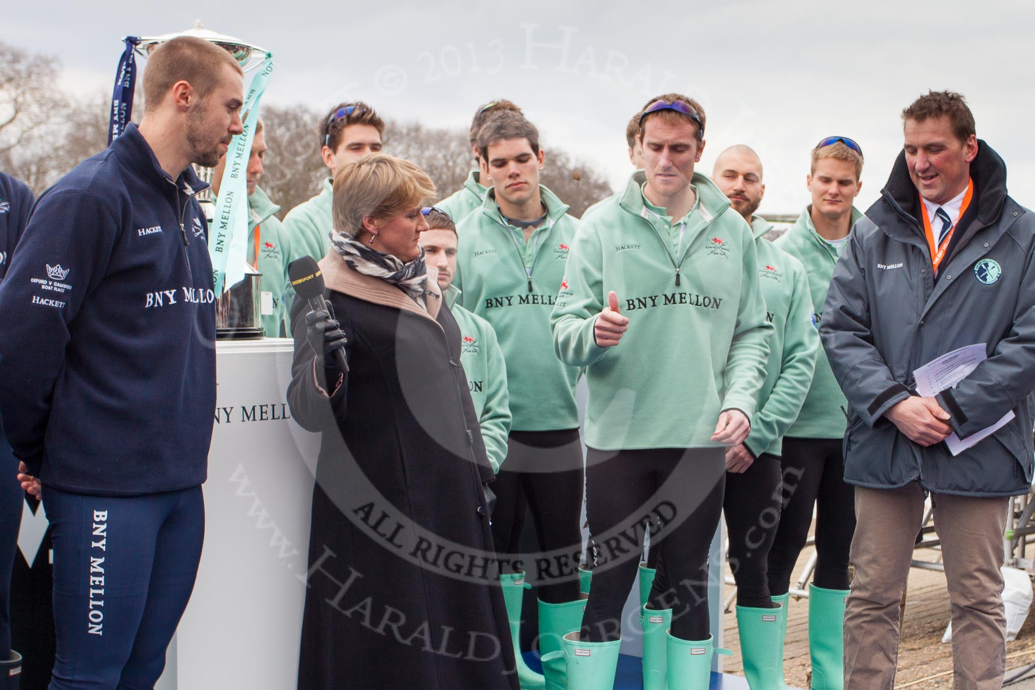 Photo 1303311446475D22853HaraldJoergens The Boat Race 2013: The "toss for stations" for the 2013 Boat Race - CUBC president, and 5 seat in the Cambridge Blue Boat, throwing the coin, BBC Sport commentator Clare balding getting out of te way, and OUBC president Alexander Davidson amd race umpire Matthew Pinsent watching..
Putney,
London SW15,
United Kingdom,
on 31 March 2013 at 14:46, image #96
