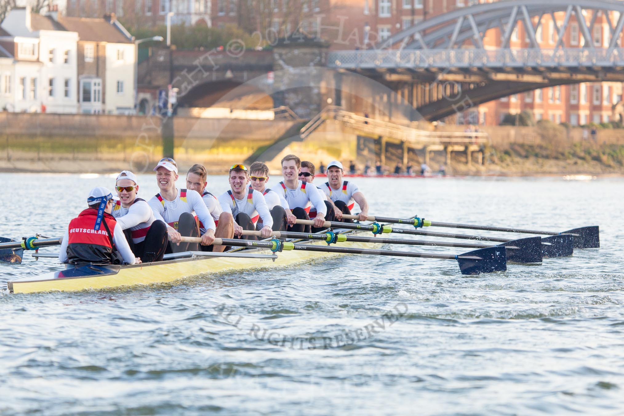 The Boat Race season 2014 - fixture OUBC vs German U23: The German U23 boat during the second race, approaching Barnes Railway Bridge: Cox Torben Johannesen, stroke Eike Kutzki, 7 Ole Schwiethal, 6 Arne Schwiethal, 5 Johannes Weissenfeld, 4 Maximilian Korge, 3 Malte Daberkow, 2 Finn Knuppel, bow Jonas Wiesen..
River Thames between Putney Bridge and Chiswick Bridge,



on 08 March 2014 at 17:07, image #234