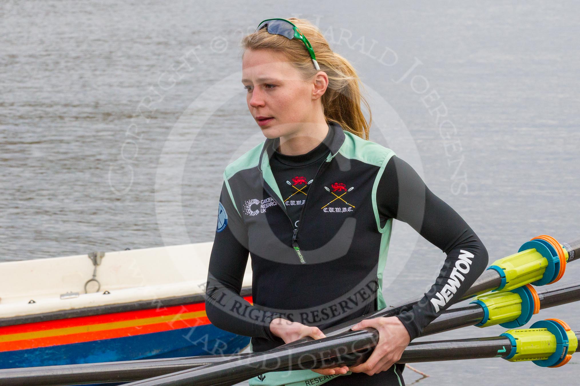 The Boat Race season 2017 - Women's Boat Race Fixture CUWBC vs Univerity of London: CUWBC's 3, Ashton Brown, carrying oars to the boat.
River Thames between Putney Bridge and Mortlake,
London SW15,

United Kingdom,
on 19 February 2017 at 15:15, image #6