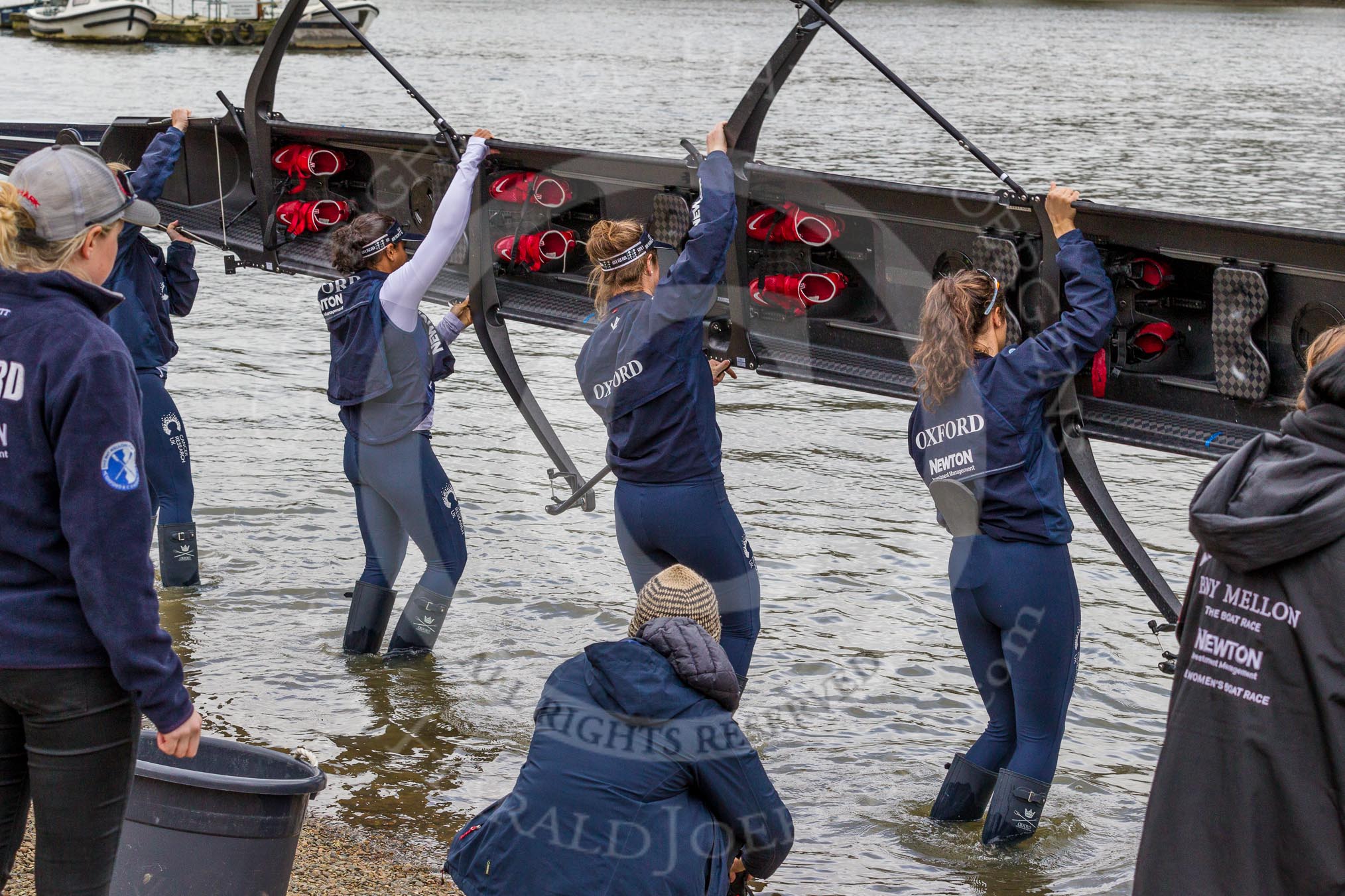 The Cancer Research UK Boat Race season 2017 - Women's Boat Race Fixture OUWBC vs Molesey BC: OUWBC turning their boat around to put it onto the river.
River Thames between Putney Bridge and Mortlake,
London SW15,

United Kingdom,
on 19 March 2017 at 15:17, image #5