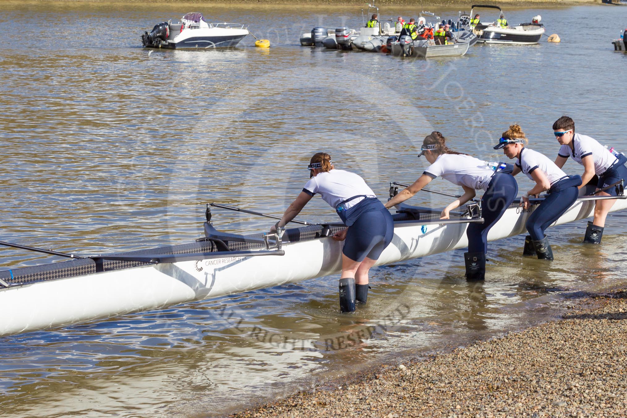 The Boat Race season 2017 -  The Cancer Research Women's Boat Race: OUWBC getting their boat onto the river, here 4 Rebecca Esselstein, 3 Rebecca Te Water Naudé, 2 Flo Pickles, bow Alice Roberts.
River Thames between Putney Bridge and Mortlake,
London SW15,

United Kingdom,
on 02 April 2017 at 15:50, image #80