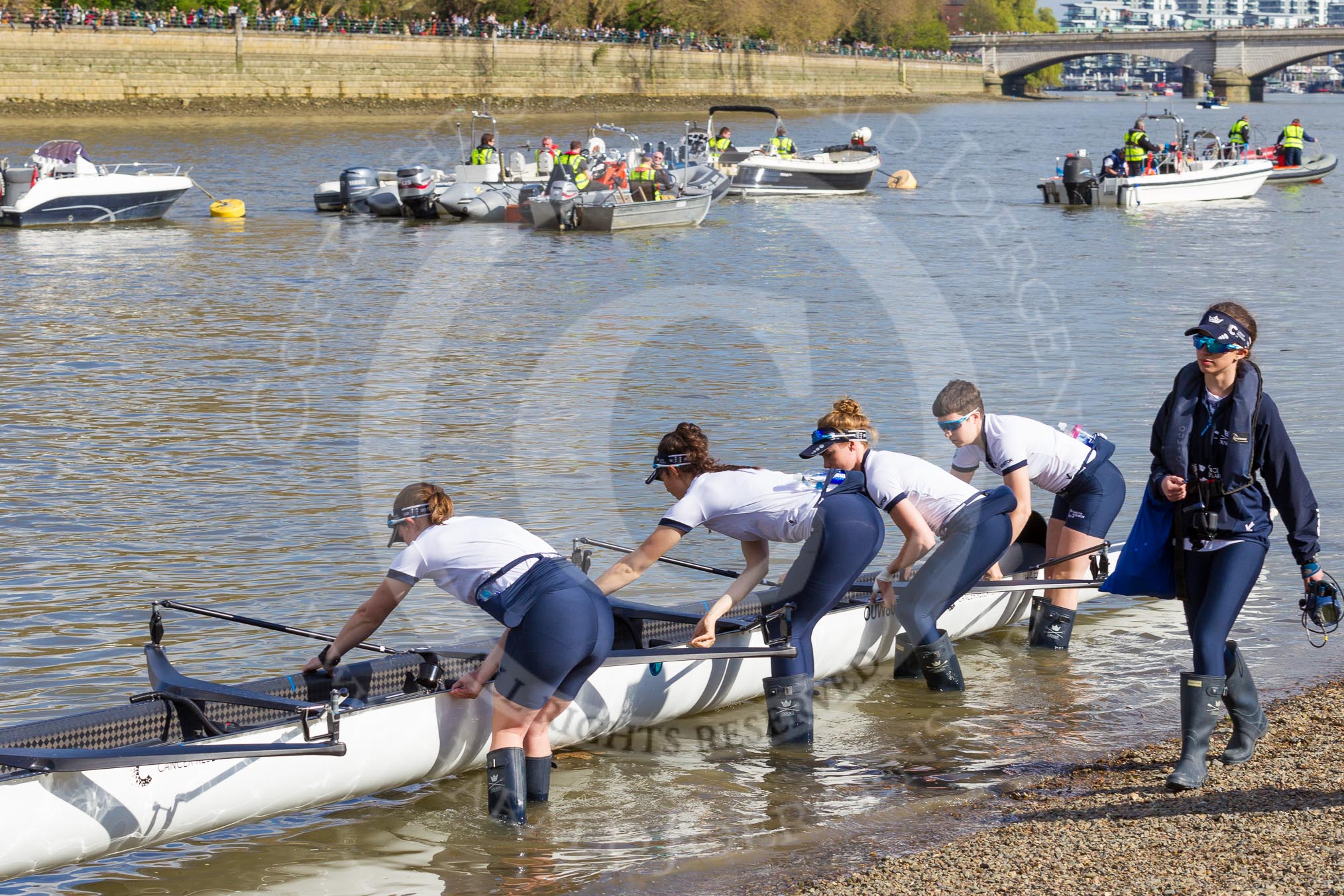 The Boat Race season 2017 -  The Cancer Research Women's Boat Race: OUWBC getting their boat into the water, here 4 Rebecca Esselstein, 3 Rebecca Te Water Naudé, 2 Flo Pickles, bow Alice Roberts, and cox Eleanor Shearer.
River Thames between Putney Bridge and Mortlake,
London SW15,

United Kingdom,
on 02 April 2017 at 15:50, image #81