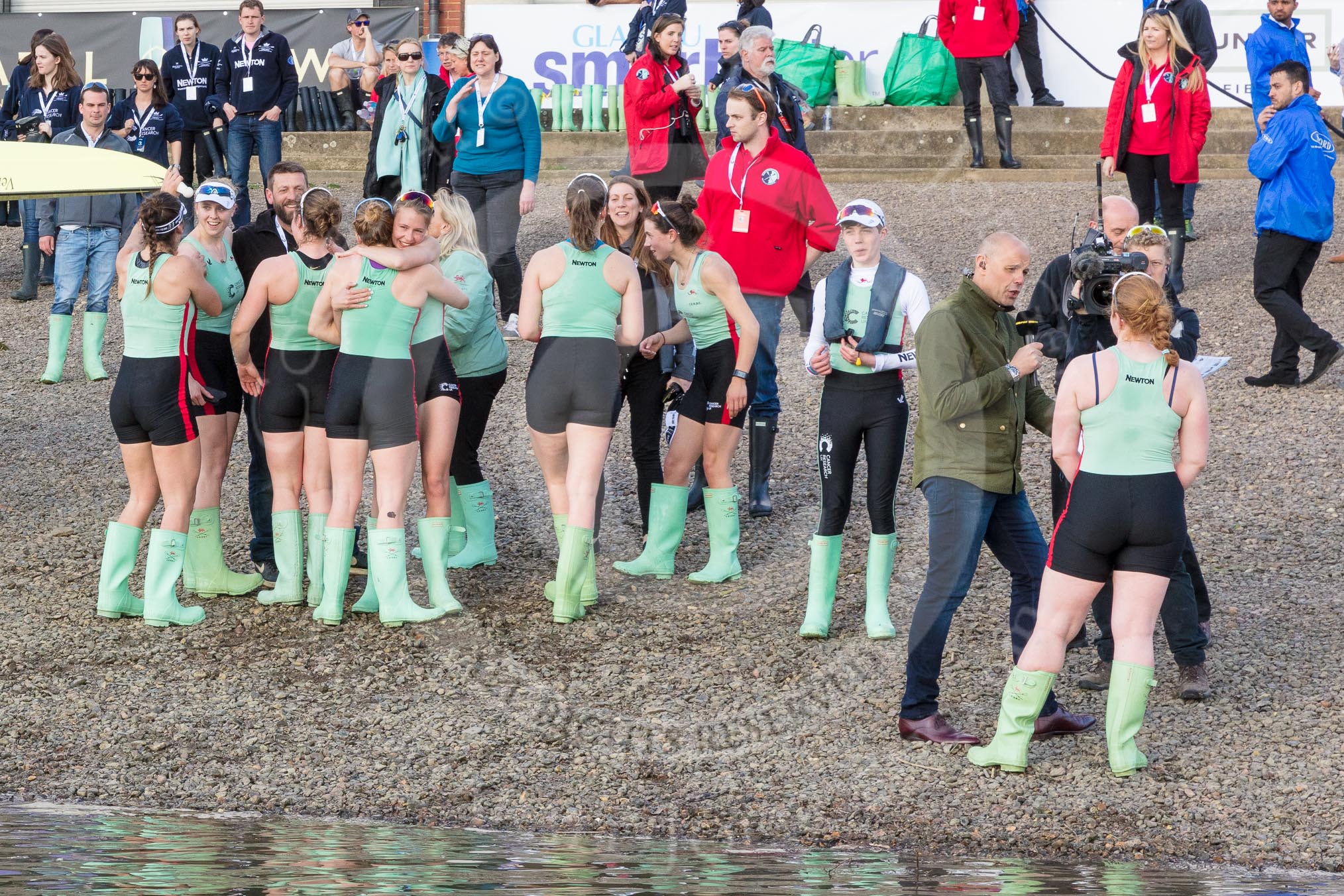 The Boat Race season 2017 -  The Cancer Research Women's Boat Race: The CUWBC crew getting together after winning the The Women's Boat Race, on the right CUWBC president Ashton Brown is giving her first live interview for the BBC's Jason Mohammad.
River Thames between Putney Bridge and Mortlake,
London SW15,

United Kingdom,
on 02 April 2017 at 17:00, image #211