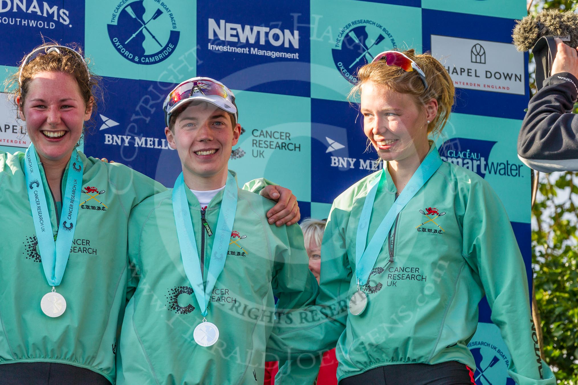 Photo 1704021711151D48425HaraldJoergens The Boat Race season 2017 - The Cancer Research Women's Boat Race: CUWBC;s stroke Melissa Wilson, cox Matthew Holland, and 3 seat Clair Lambe with their medals at the price giving.
River Thames between Putney Bridge and Mortlake,
London SW15,
United Kingdom,
on 02 April 2017 at 17:11, image #228