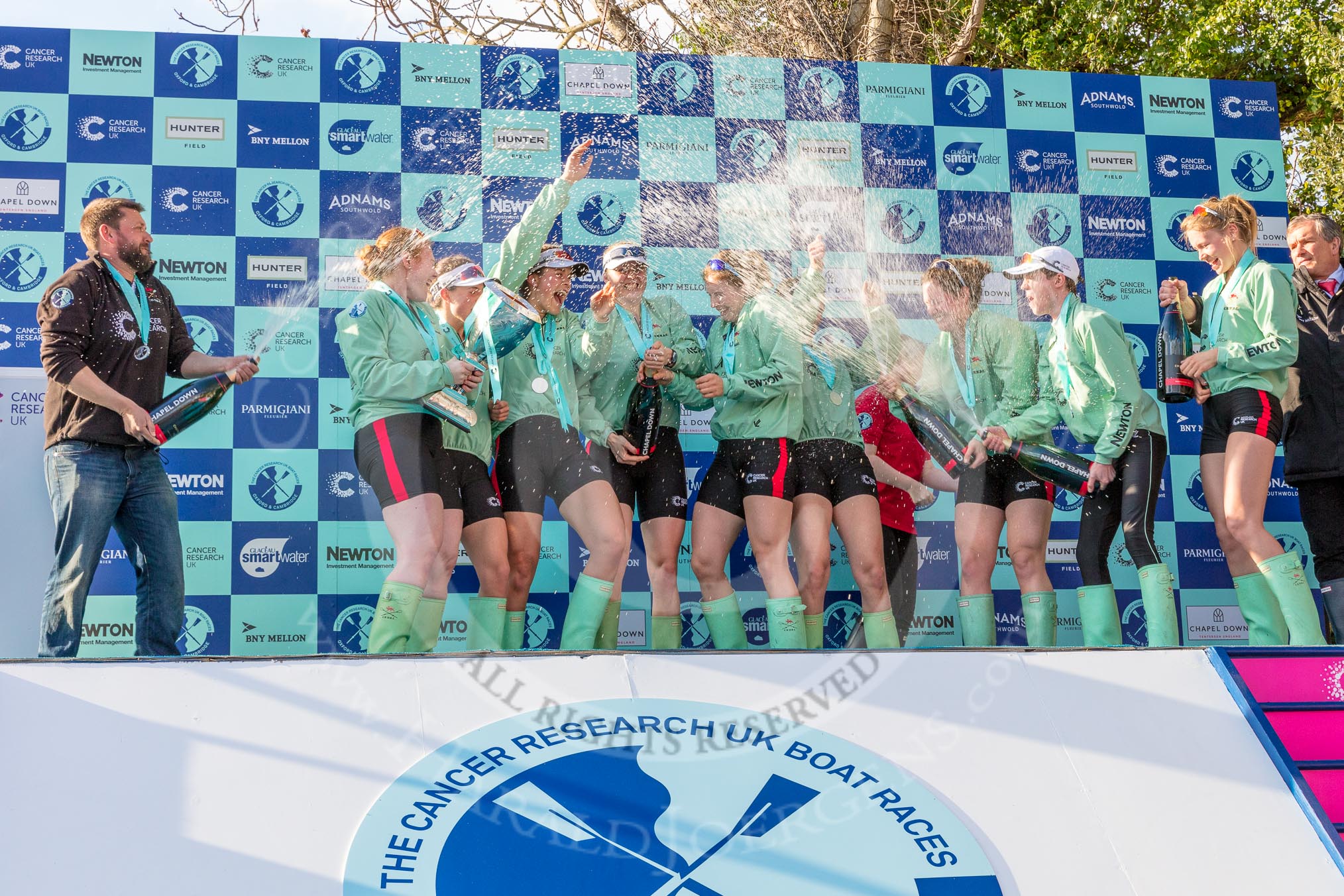 The Boat Race season 2017 -  The Cancer Research Women's Boat Race: CUWBC spraying the Champagne at the price giving - 5 seat Holly Hill, 6 seat Alice White, 7 seat Myriam Goudet, stroke Melissa Wilson, and cox Matthew Holland, and 4 seat Anna Dawson.
River Thames between Putney Bridge and Mortlake,
London SW15,

United Kingdom,
on 02 April 2017 at 17:13, image #262