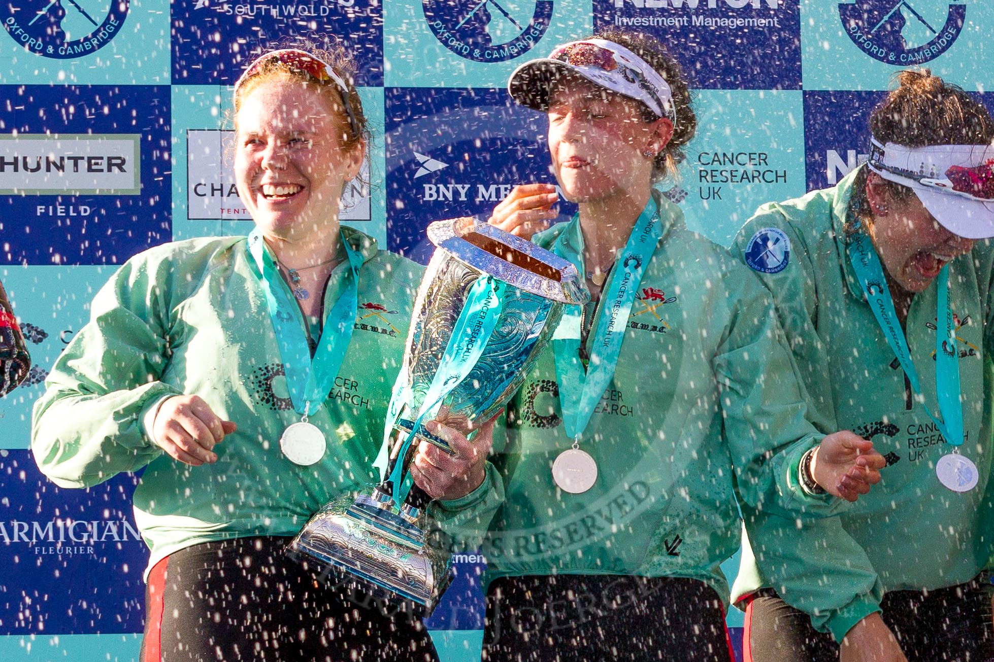 The Boat Race season 2017 -  The Cancer Research Women's Boat Race: CUWBC and lots of Champagne, here, with the Women's Boat Race trophy, bow Ashton Brown, 2 Imogen Grant, and 3 Claire Lambe.
River Thames between Putney Bridge and Mortlake,
London SW15,

United Kingdom,
on 02 April 2017 at 17:13, image #274