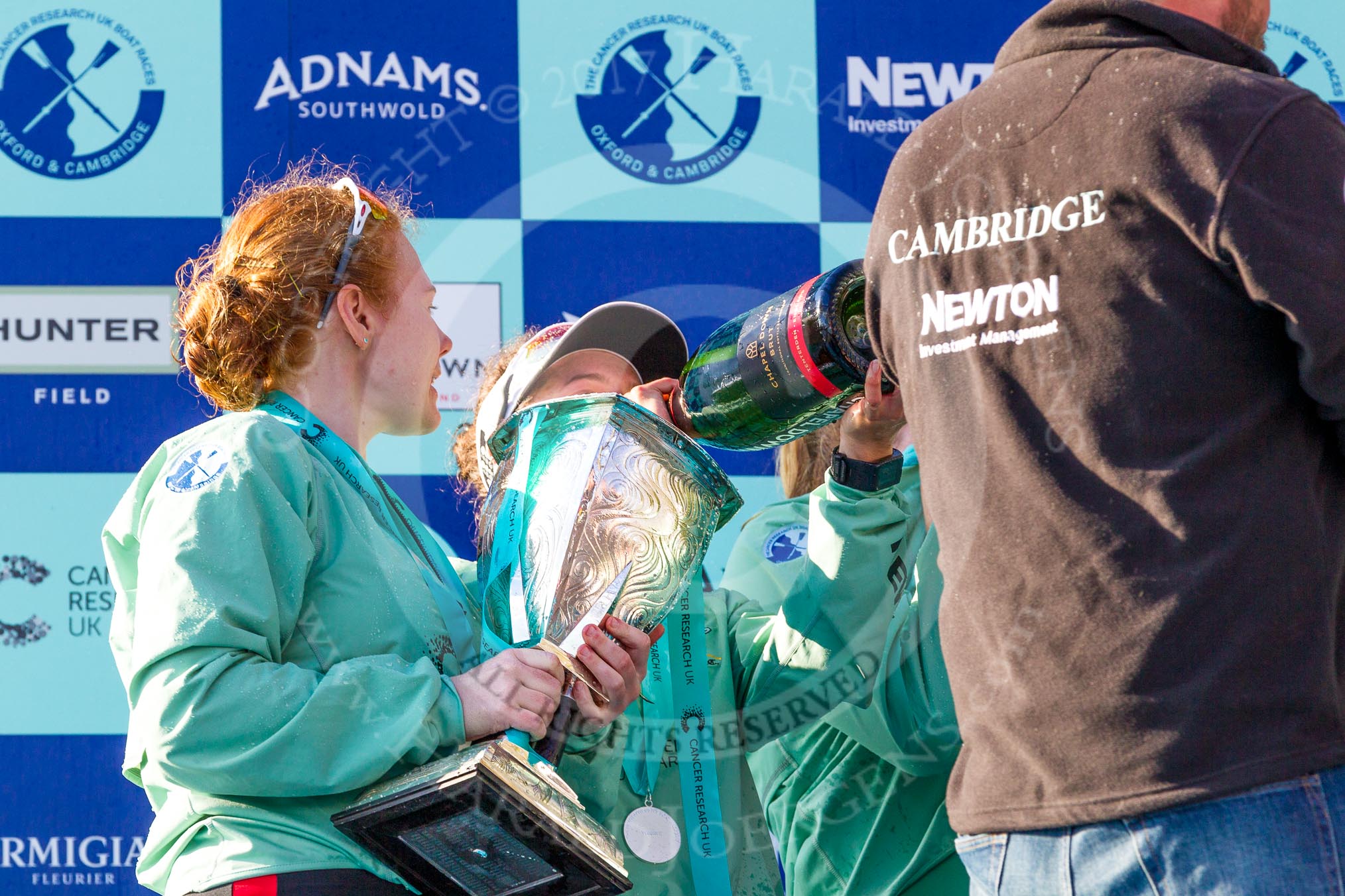 The Boat Race season 2017 -  The Cancer Research Women's Boat Race: CUWBC president Ashton Brown with the Women's Boat Race trophy at the price giving, on her right Imogen Grant enjoying Champagne.
River Thames between Putney Bridge and Mortlake,
London SW15,

United Kingdom,
on 02 April 2017 at 17:13, image #279