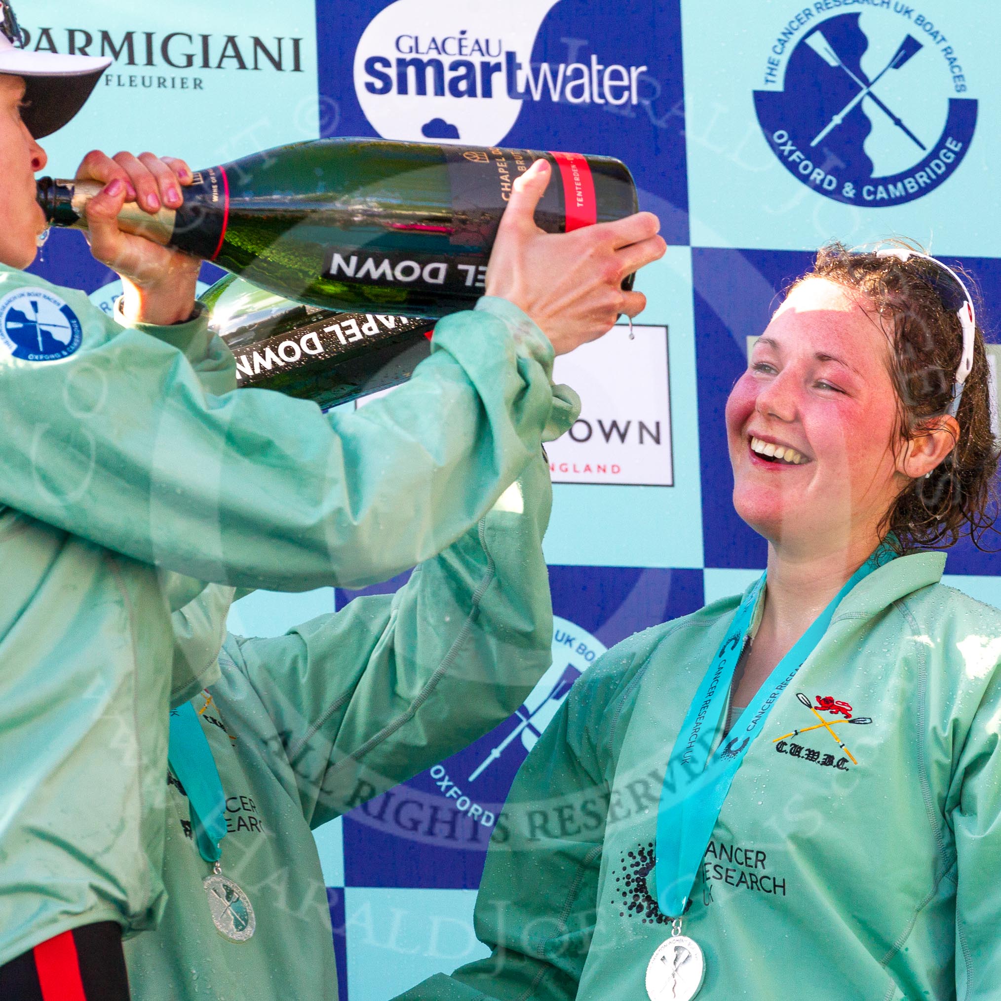 The Boat Race season 2017 -  The Cancer Research Women's Boat Race: CUWBC working hard to empty the bottles of Champagne at the price giving - on the right stroke Melissa Wilson.
River Thames between Putney Bridge and Mortlake,
London SW15,

United Kingdom,
on 02 April 2017 at 17:13, image #281