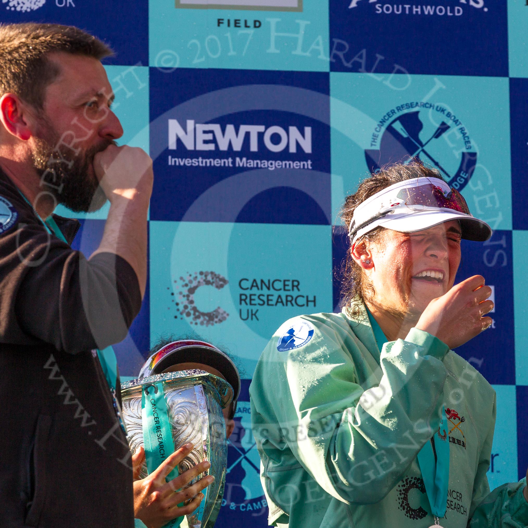 The Boat Race season 2017 -  The Cancer Research Women's Boat Race: CUWBC after the Chanpange spraying at the price giving - head coach Rob Barker, (possibly) Imogen Grant with the Women's Boat Race trophy, and Claire Lambe.
River Thames between Putney Bridge and Mortlake,
London SW15,

United Kingdom,
on 02 April 2017 at 17:13, image #282