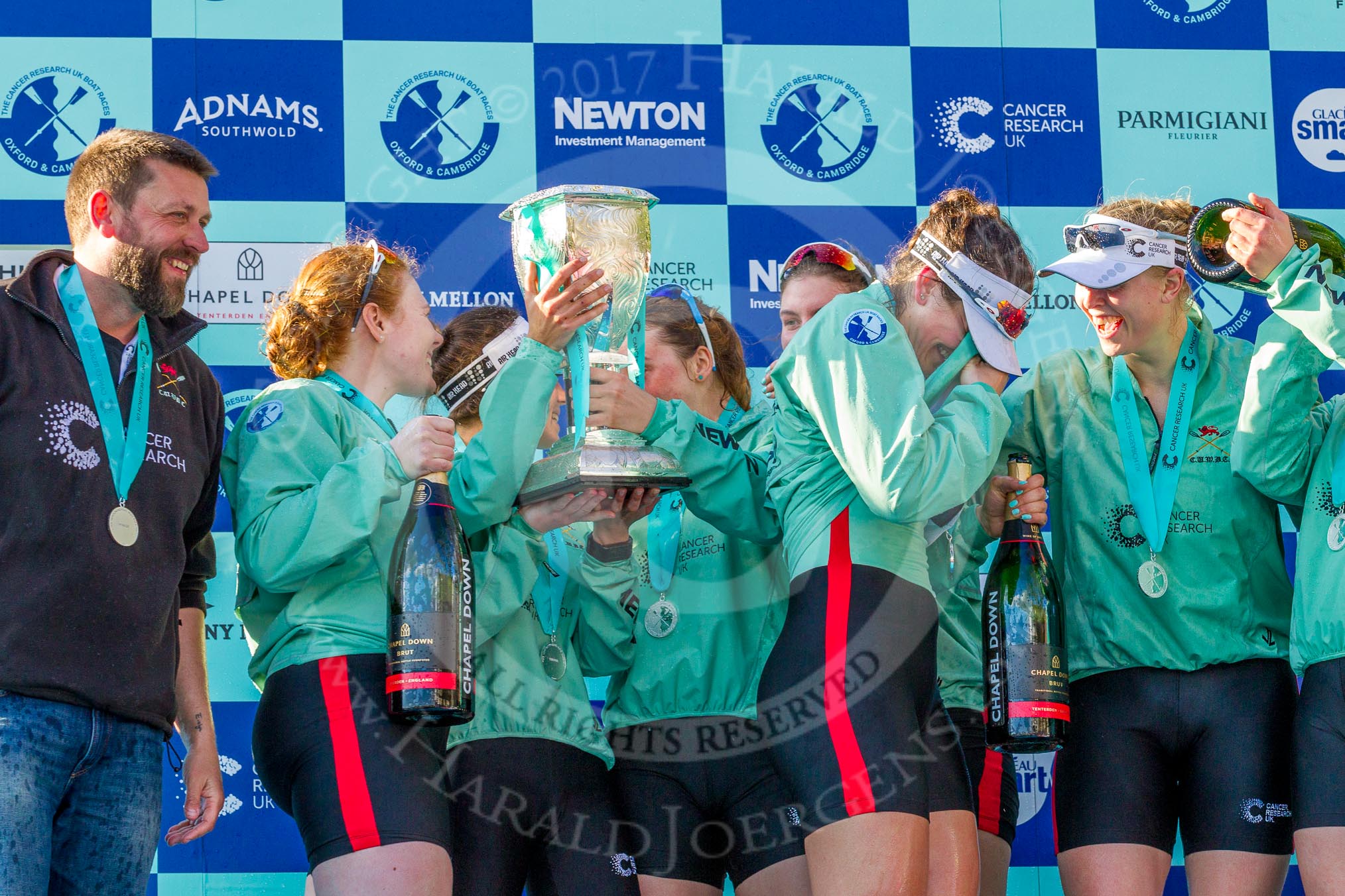 The Boat Race season 2017 -  The Cancer Research Women's Boat Race: CUWBC after the Chanpange spraying at the price giving, with the Women's Boat Race trophy. On the left head coach Rob Barker.
River Thames between Putney Bridge and Mortlake,
London SW15,

United Kingdom,
on 02 April 2017 at 17:13, image #288