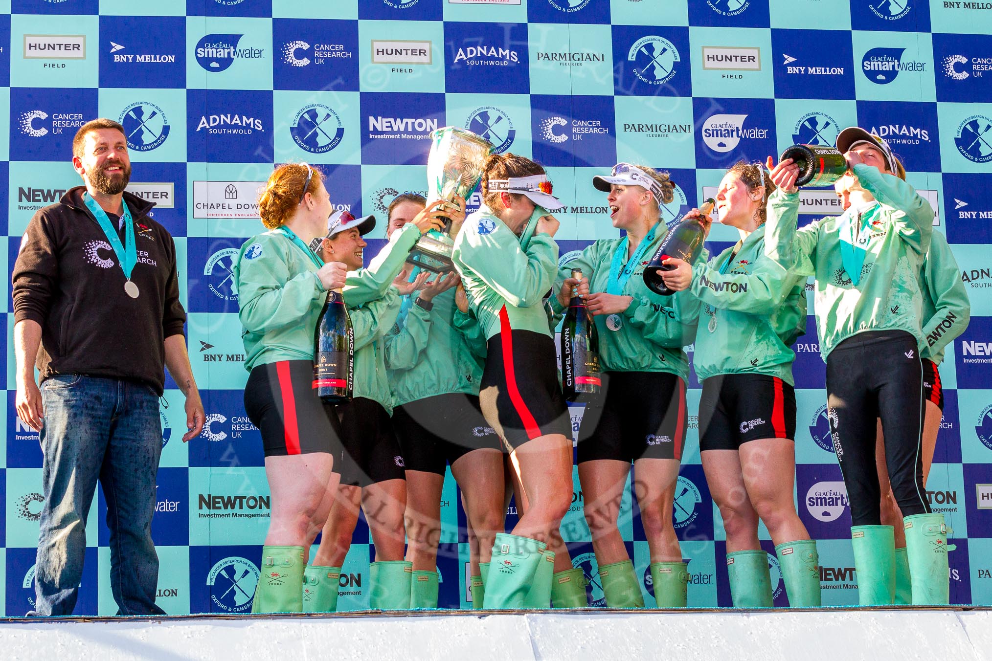 The Boat Race season 2017 -  The Cancer Research Women's Boat Race: CUWBC after the Chanpange spraying at the price giving, with the Women's Boat Race trophy. On the left head coach Rob Barker.
River Thames between Putney Bridge and Mortlake,
London SW15,

United Kingdom,
on 02 April 2017 at 17:13, image #289