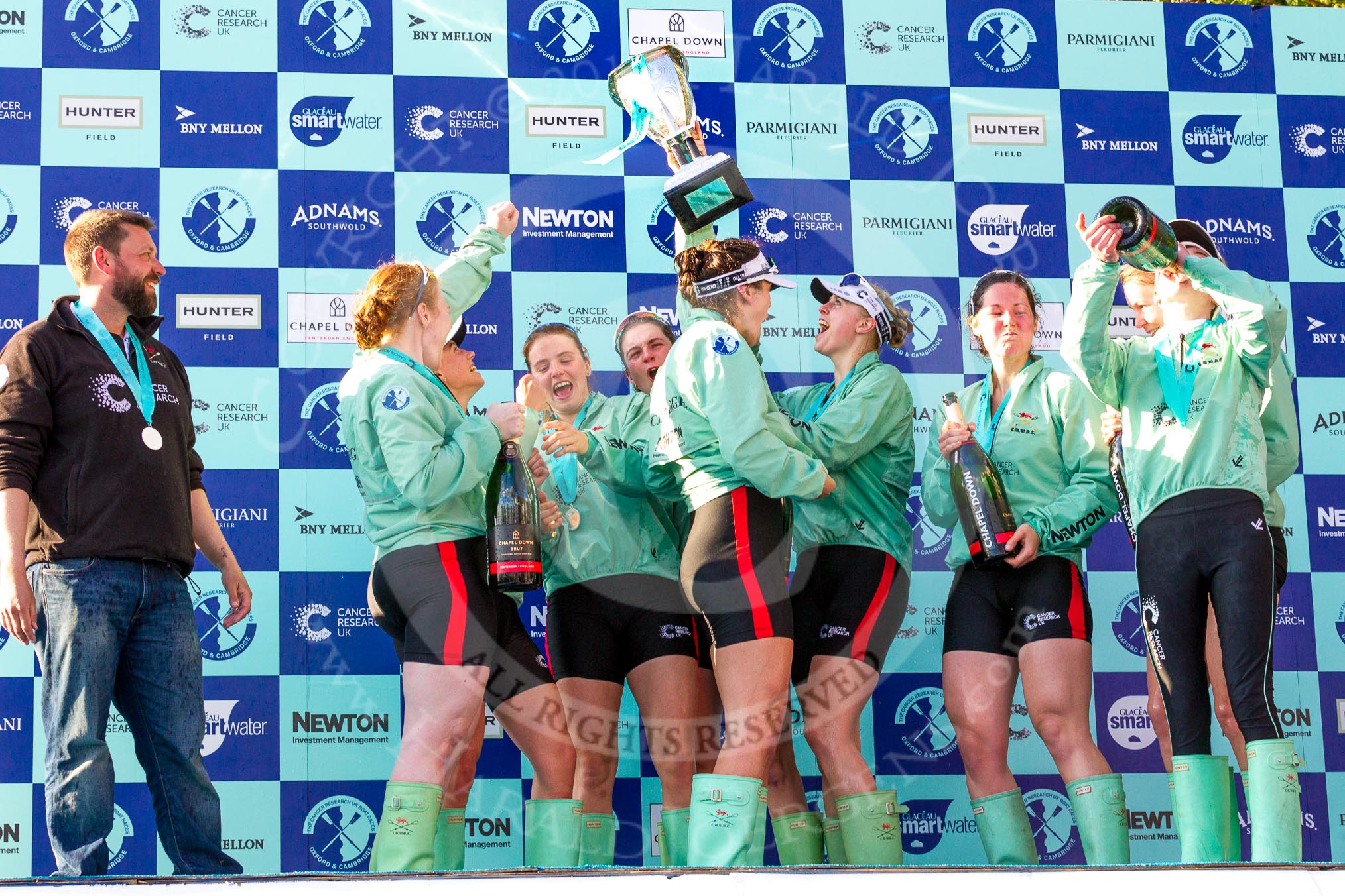 The Boat Race season 2017 -  The Cancer Research Women's Boat Race: CUWBC after the Chanpange spraying at the price giving, with the Women's Boat Race trophy. On the left head coach Rob Barker.
River Thames between Putney Bridge and Mortlake,
London SW15,

United Kingdom,
on 02 April 2017 at 17:13, image #290