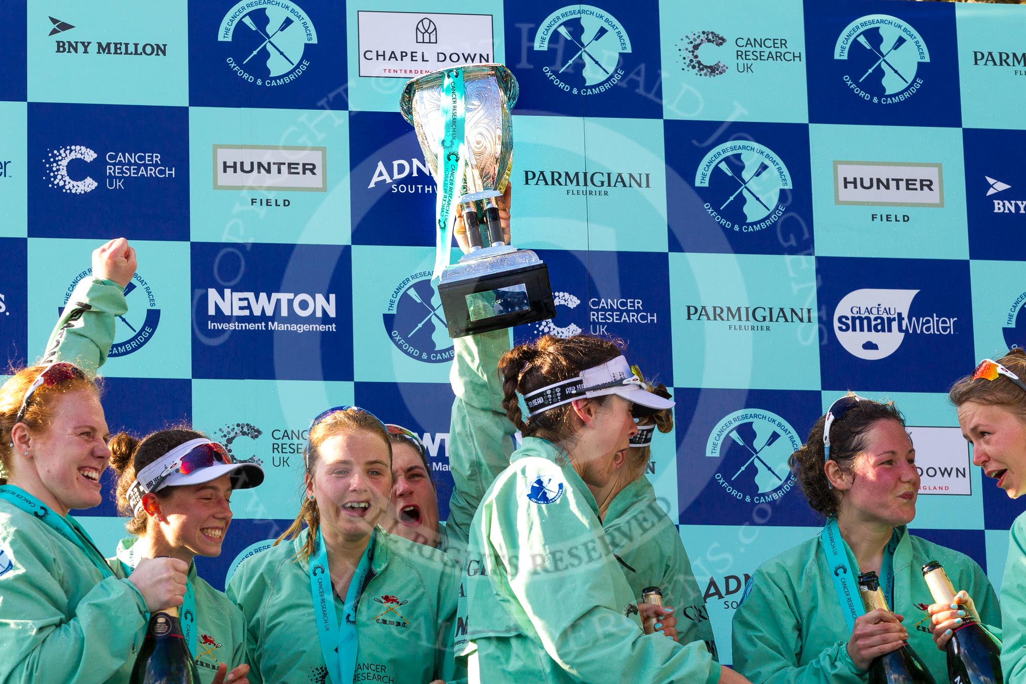 The Boat Race season 2017 -  The Cancer Research Women's Boat Race: CUWBC after the Chanpange spraying at the price giving, with the Women's Boat Race trophy. Ashton Brown, Imogen Grant, Alice White, Claire Lambe, and on the right Melissa Wilson and Anna Dawson.
River Thames between Putney Bridge and Mortlake,
London SW15,

United Kingdom,
on 02 April 2017 at 17:13, image #291