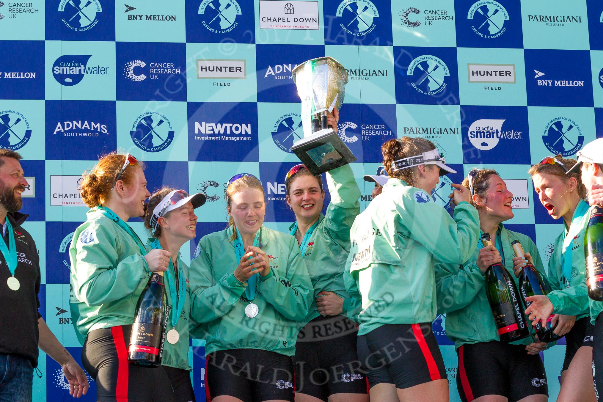 The Boat Race season 2017 -  The Cancer Research Women's Boat Race: CUWBC with the Womwn's Boat Race trophy at the price giving - head coach Rob Baker, bow Ashton Brown, 2 Imogen Grant, 6 Alice White, 7 Myriam Goudet, and on the right stroke Melissa Wilson and 4 Anna Dawson.
River Thames between Putney Bridge and Mortlake,
London SW15,

United Kingdom,
on 02 April 2017 at 17:13, image #293