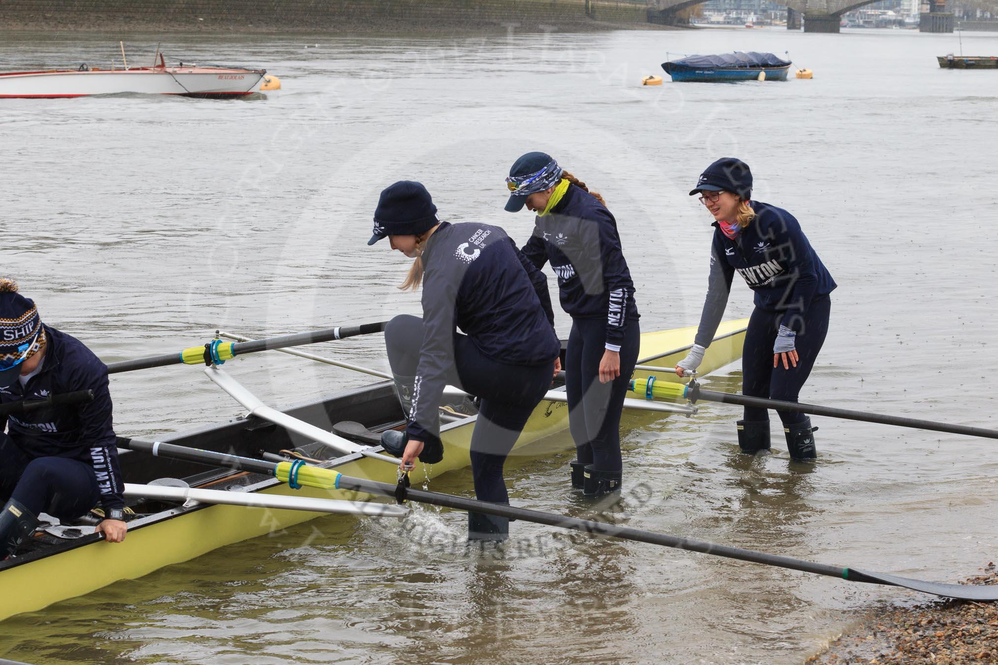 The Women's Boat Race season 2018 - fixture OUWBC vs. Molesey BC: OUWBC getting the boat ready on a cold and rainy day, here 4 seat Alice Roberts, 3 Juliette Perry, 2 Katherine Erickson, bow Renée Koolschijn.
River Thames between Putney Bridge and Mortlake,
London SW15,

United Kingdom,
on 04 March 2018 at 13:04, image #1
