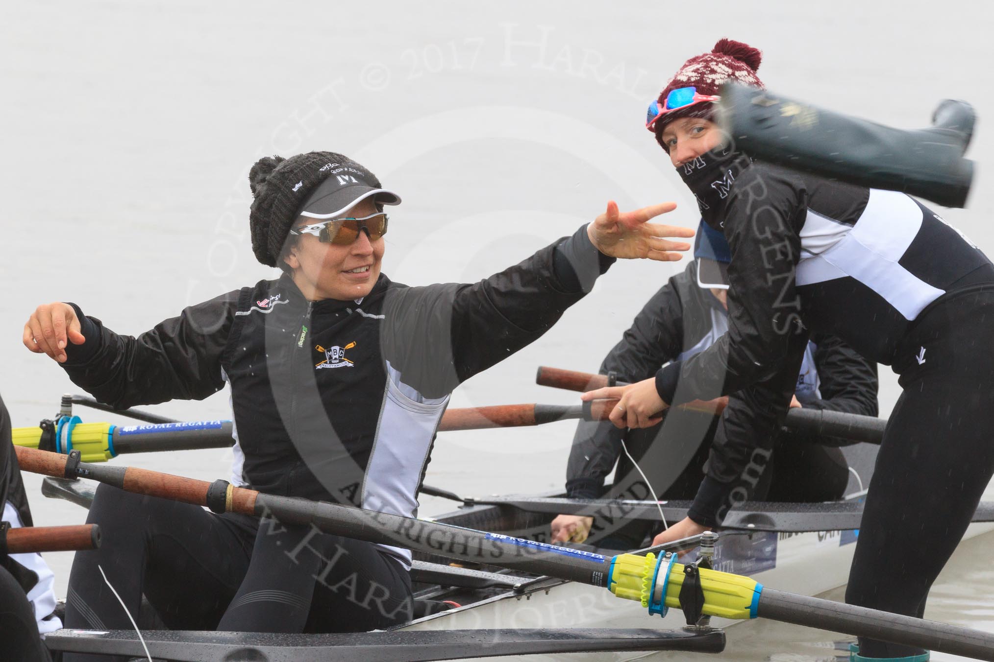 The Women's Boat Race season 2018 - fixture OUWBC vs. Molesey BC: Molesey's 3 seat Gabby Rodriguez throwing one of  her wellies, 2 seat Lucy Primmer, and bow Emma Boyns.
River Thames between Putney Bridge and Mortlake,
London SW15,

United Kingdom,
on 04 March 2018 at 13:09, image #18