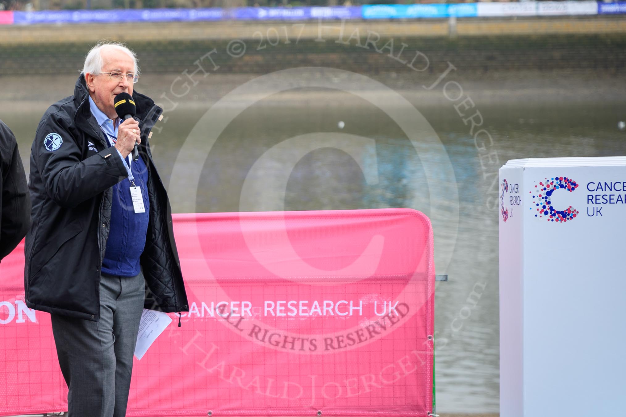 The Cancer Research UK Women's Boat Race 2018: Sports broadcaster David Mercer commentating the toss.
River Thames between Putney Bridge and Mortlake,
London SW15,

United Kingdom,
on 24 March 2018 at 14:28, image #28