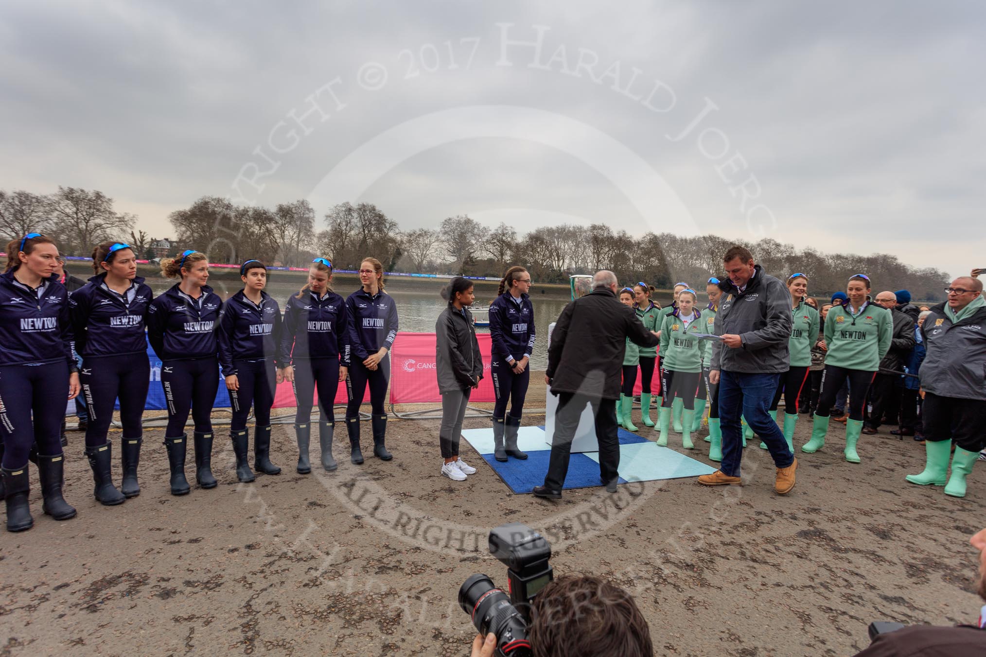 The Cancer Research UK Women's Boat Race 2018: The Women's Boat Race toss - Oxford on the left of the photo, Cambridge on the right, race umpire Sir Matthew Pinsent in front of Cambridge.
River Thames between Putney Bridge and Mortlake,
London SW15,

United Kingdom,
on 24 March 2018 at 14:40, image #31