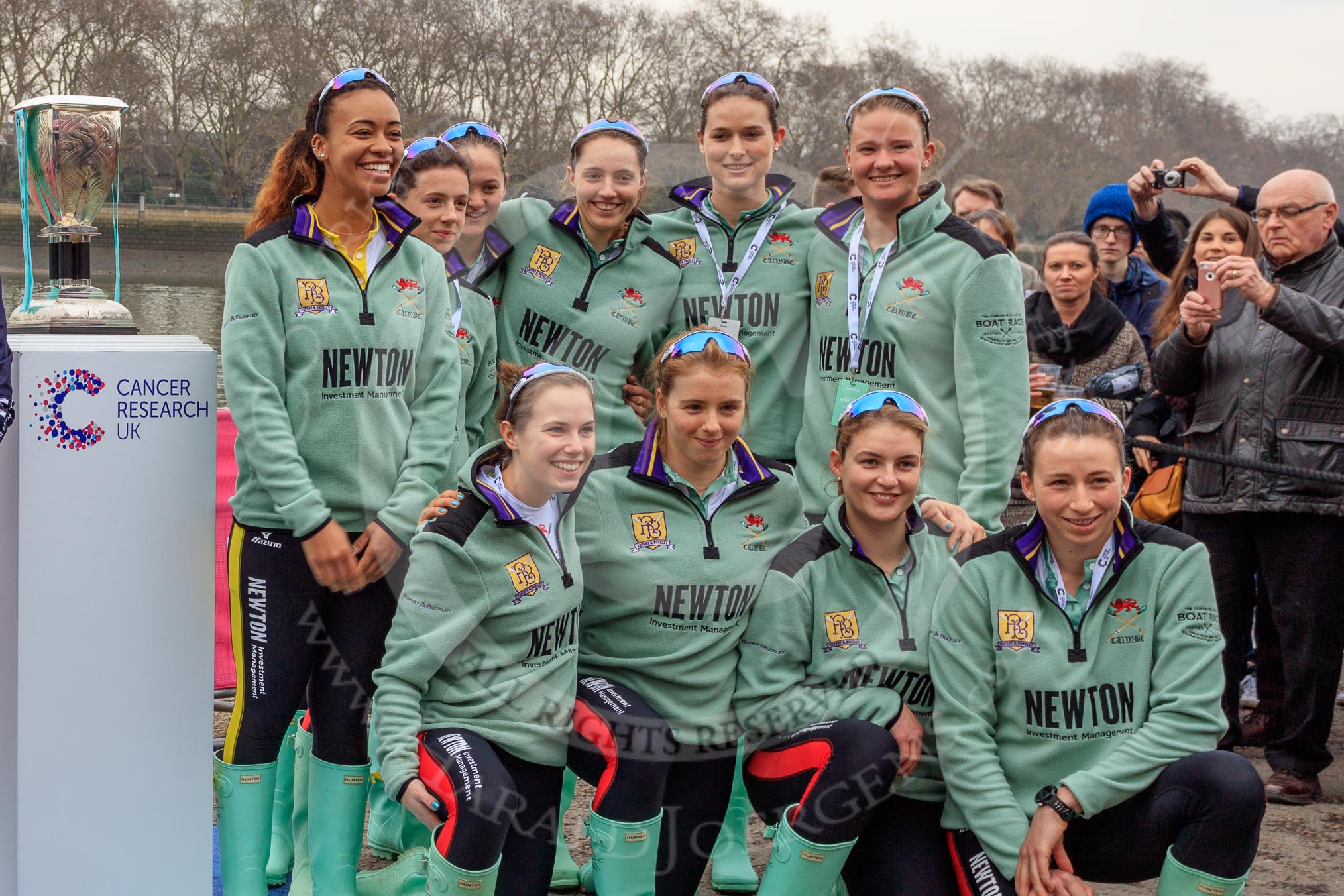 The Cancer Research UK Women's Boat Race 2018: The Cambridge crew  at the toss - president Daphne Martschenko (rowing in the reserve boat), cox Sophie Shapter, 6 Alice White, 7 Myriam Goudet-Boukhatmi, and in the second row 2 seat Imogen Grant, 3 Kelsey Barolak, 4 Thea Zabell, and 5 Paula Wesselmann..
River Thames between Putney Bridge and Mortlake,
London SW15,

United Kingdom,
on 24 March 2018 at 14:42, image #59