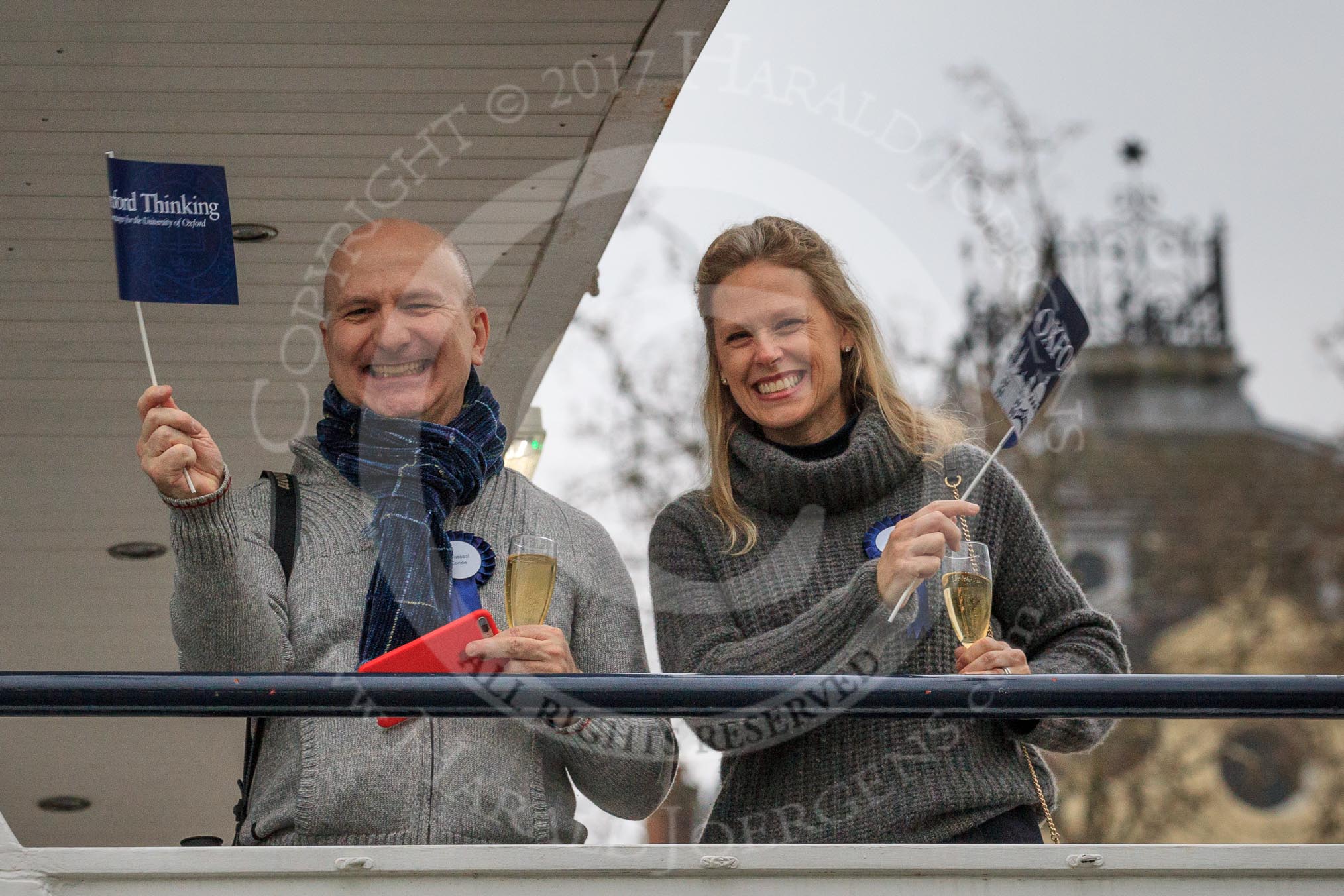 The Cancer Research UK Women's Boat Race 2018: A couple on board of Erasmus, a Thames passenger ship booked for friends and realives of Oxford, and moored close to the start line.
River Thames between Putney Bridge and Mortlake,
London SW15,

United Kingdom,
on 24 March 2018 at 16:16, image #143