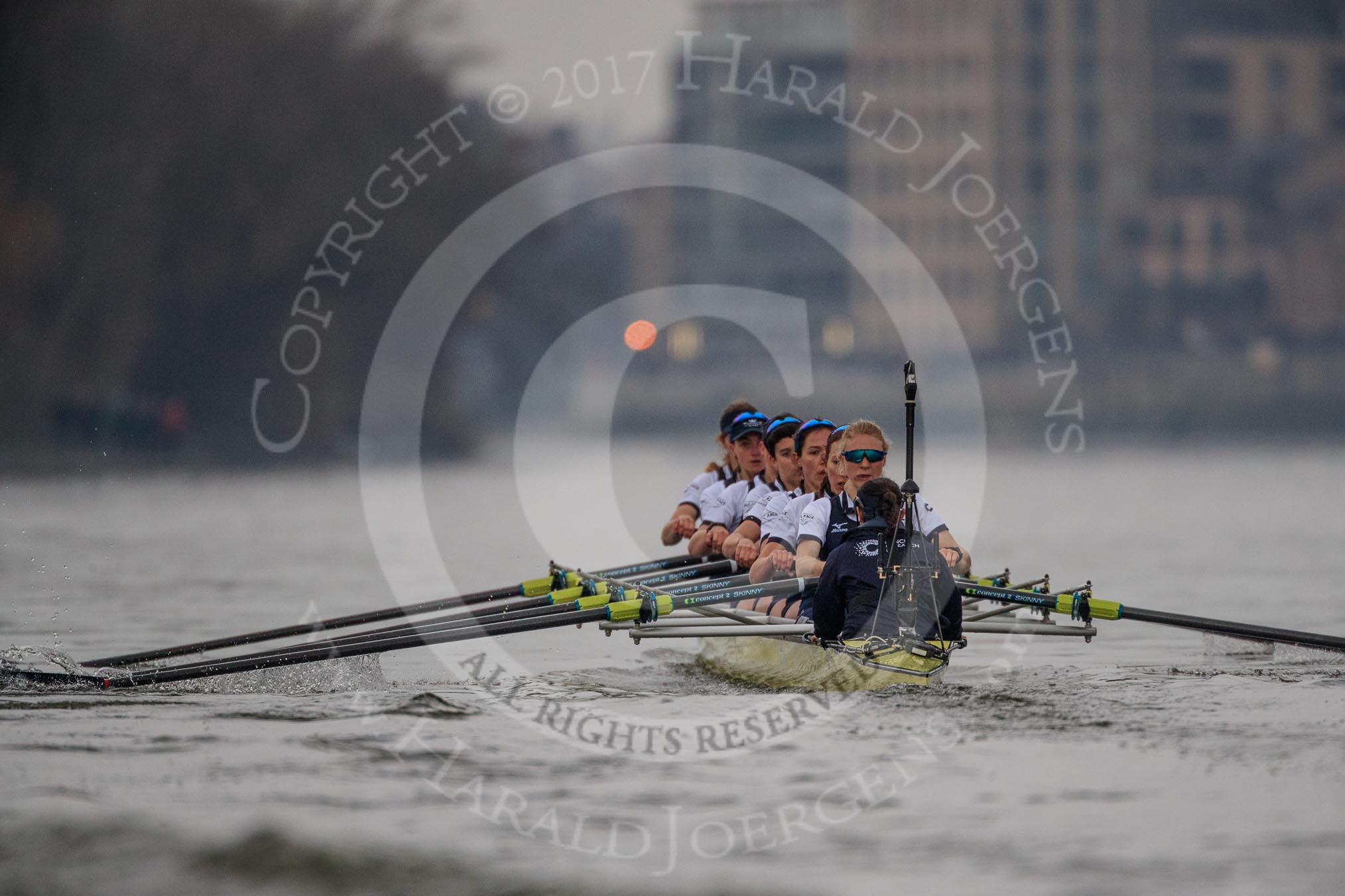 The Cancer Research UK Women's Boat Race 2018: The Oxford Blue Boat chasing Cambridge near Craven Cottage - cox Jessica Buck, stroke Beth Bridgman, 7 Abigail Killen, 6 Sara Kushma, 5 Morgan McGovern, 4 Alice Roberts, 3 Juliette Perry, 2 Katherine Erickson, bow Renée Koolschijn.
River Thames between Putney Bridge and Mortlake,
London SW15,

United Kingdom,
on 24 March 2018 at 16:34, image #171