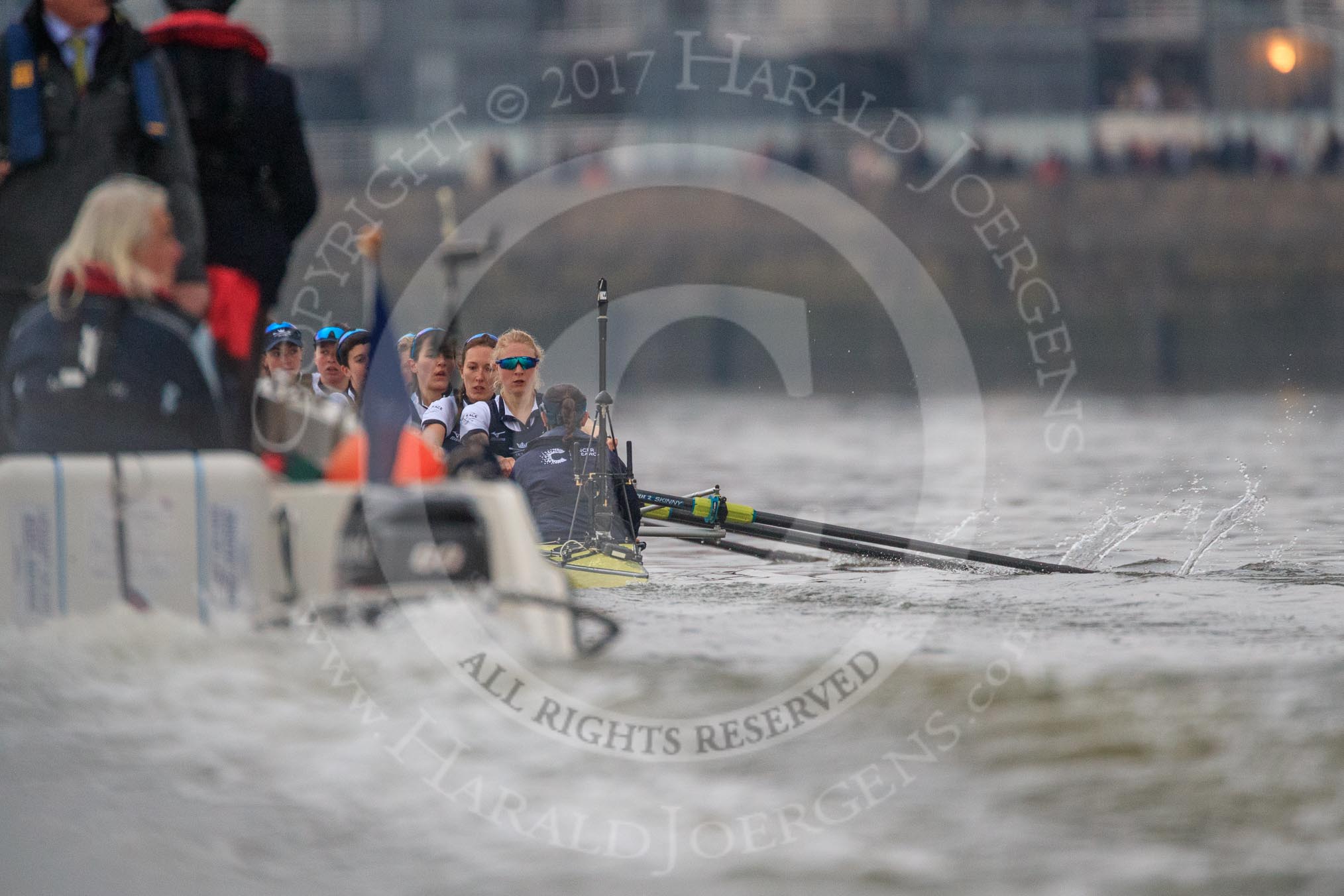 Photo 1803241636061X24581HaraldJoergens The Cancer Research UK Women's Boat Race 2018: The Oxford Blue Boat nearly hidden by the umpire's launch - bow Renée Koolschijn, 2 Katherine Erickson, 3 Juliette Perry, 4 Alice Roberts, 5 Morgan McGovern, 6 Sara Kushma, 7 Abigail Killen, stroke Beth Bridgman, cox Jessica Buck.
River Thames between Putney Bridge and Mortlake,
London SW15,
United Kingdom,
on 24 March 2018 at 16:36, image #173
