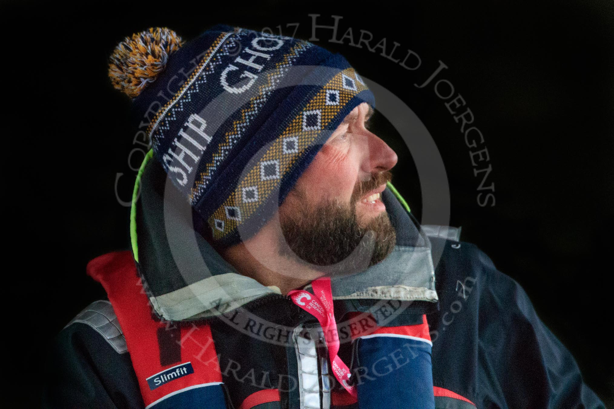 The Cancer Research UK Women's Boat Race 2018: CUWBC Head Coach Rob Baker in the shadow of a bridge.
River Thames between Putney Bridge and Mortlake,
London SW15,

United Kingdom,
on 24 March 2018 at 16:39, image #184
