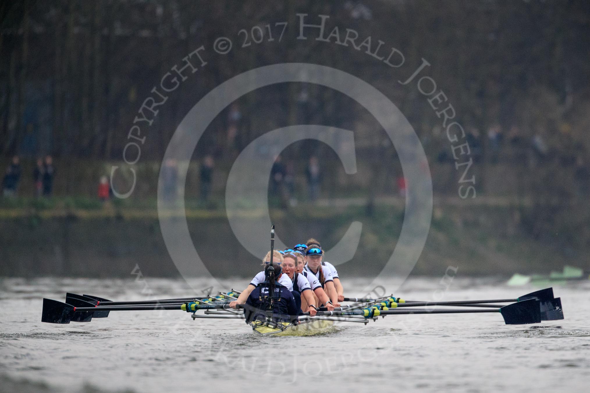 The Cancer Research UK Women's Boat Race 2018: The Oxford boat - cox Jessica Buck, stroke Beth Bridgman, 7 Abigail Killen, 6 Sara Kushma, 5 Morgan McGovern, 4 Alice Roberts, 3 Juliette Perry, 2 Katherine Erickson, bow Renée Koolschijn
. Just visible on the right is the leading Cambridge boat.
River Thames between Putney Bridge and Mortlake,
London SW15,

United Kingdom,
on 24 March 2018 at 16:47, image #202