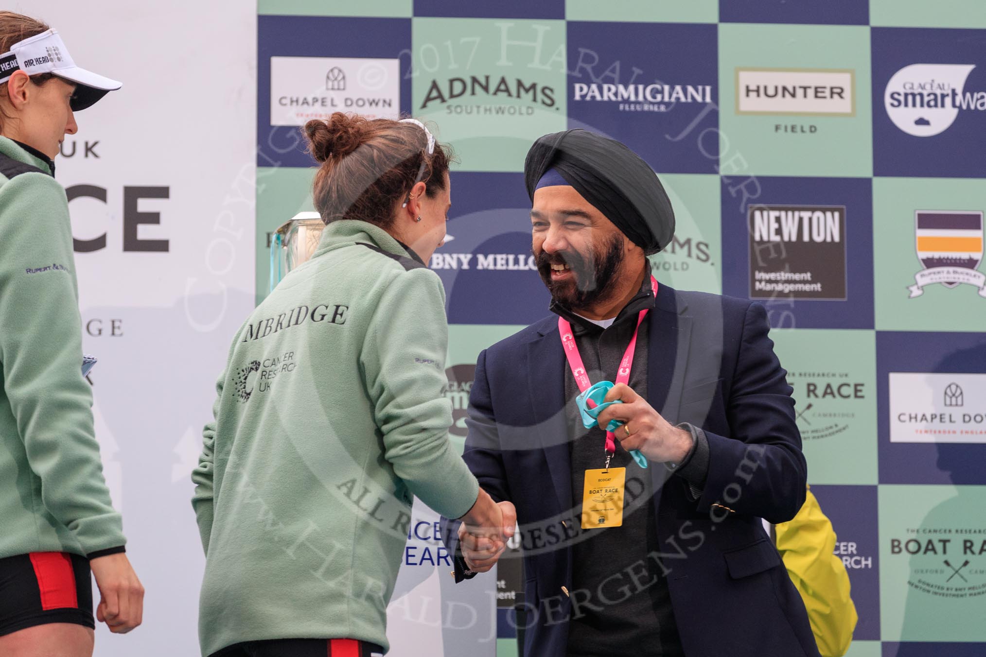 The Cancer Research UK Women's Boat Race 2018: Sir Harpal Kumar, CEO of Cancer Research UK. congratulating Cambridge 2 seat Imogen Grant at the trophy presentation.
River Thames between Putney Bridge and Mortlake,
London SW15,

United Kingdom,
on 24 March 2018 at 17:06, image #251