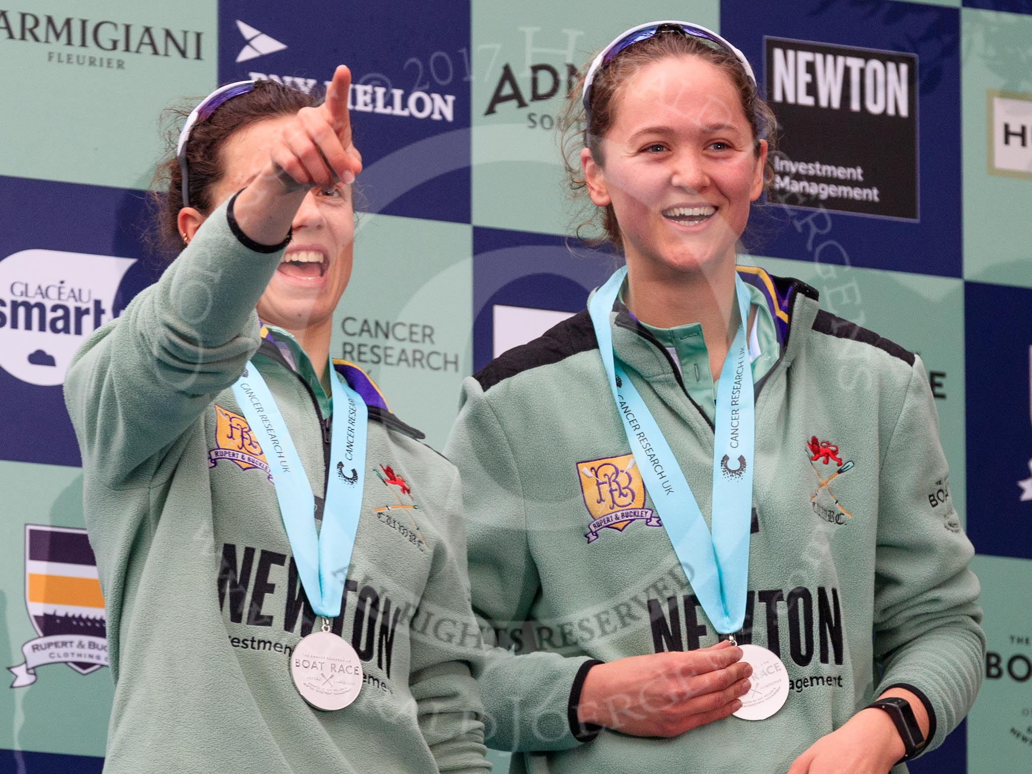 Photo 1803241706481X25291HaraldJoergens The Cancer Research UK Women's Boat Race 2018: Cambridge 2 seat Imogen Grant and bow seat Tricia Smith, with her Women's Boat Race medals. on the podium.
River Thames between Putney Bridge and Mortlake,
London SW15,
United Kingdom,
on 24 March 2018 at 17:06, image #255