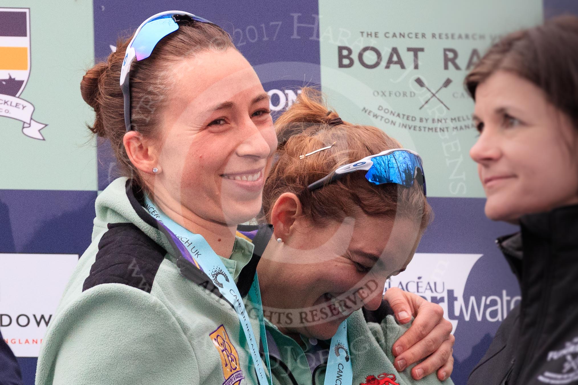 Photo 1803241707301X25337HaraldJoergens The Cancer Research UK Women's Boat Race 2018: Cambridge stroke Olivia Coffey and 5 sseat Paula Wesselmann, with her Women's Boat Race medals. on the podium.
River Thames between Putney Bridge and Mortlake,
London SW15,
United Kingdom,
on 24 March 2018 at 17:07, image #263
