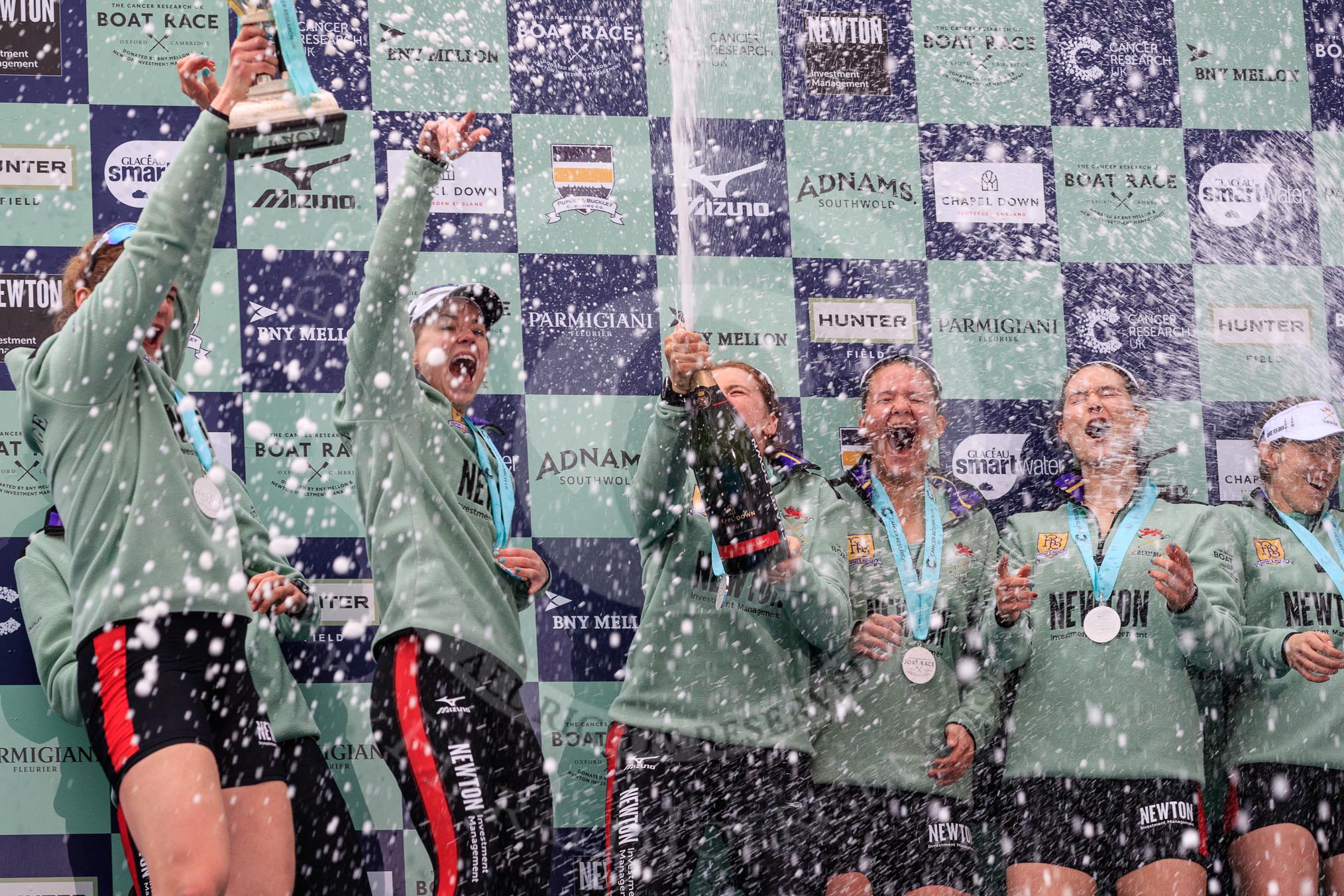 The Cancer Research UK Women's Boat Race 2018: Cambridge celebrations, with lots of champagne (actually Chapel Down Brut) on the podium, after winning the Women's Boat Race.
River Thames between Putney Bridge and Mortlake,
London SW15,

United Kingdom,
on 24 March 2018 at 17:09, image #278